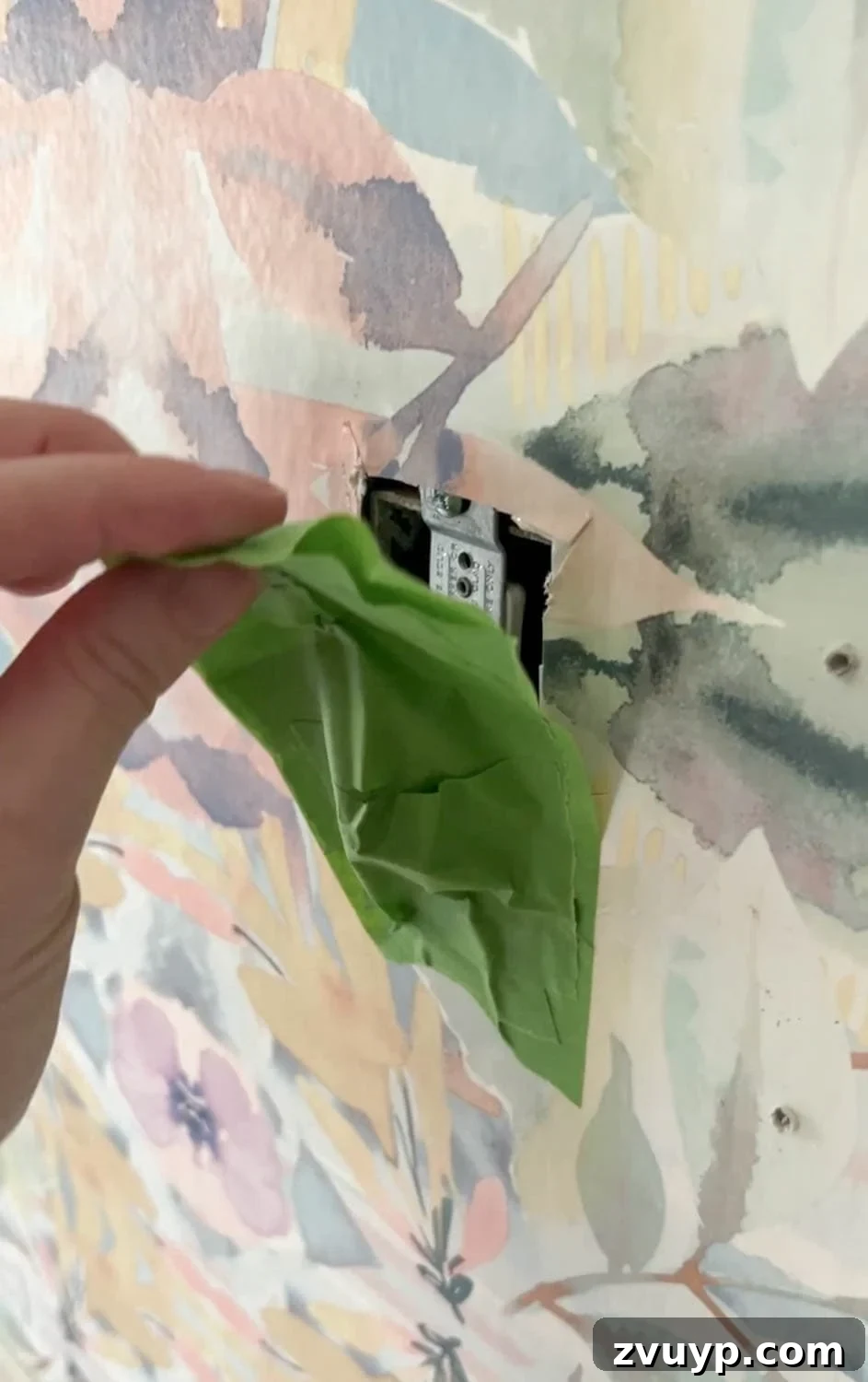 Mastering Wallpaper Removal: 3 Tried and True Methods 6 Covering outlets and switches with painter's tape before wallpaper removal to protect electrical wiring