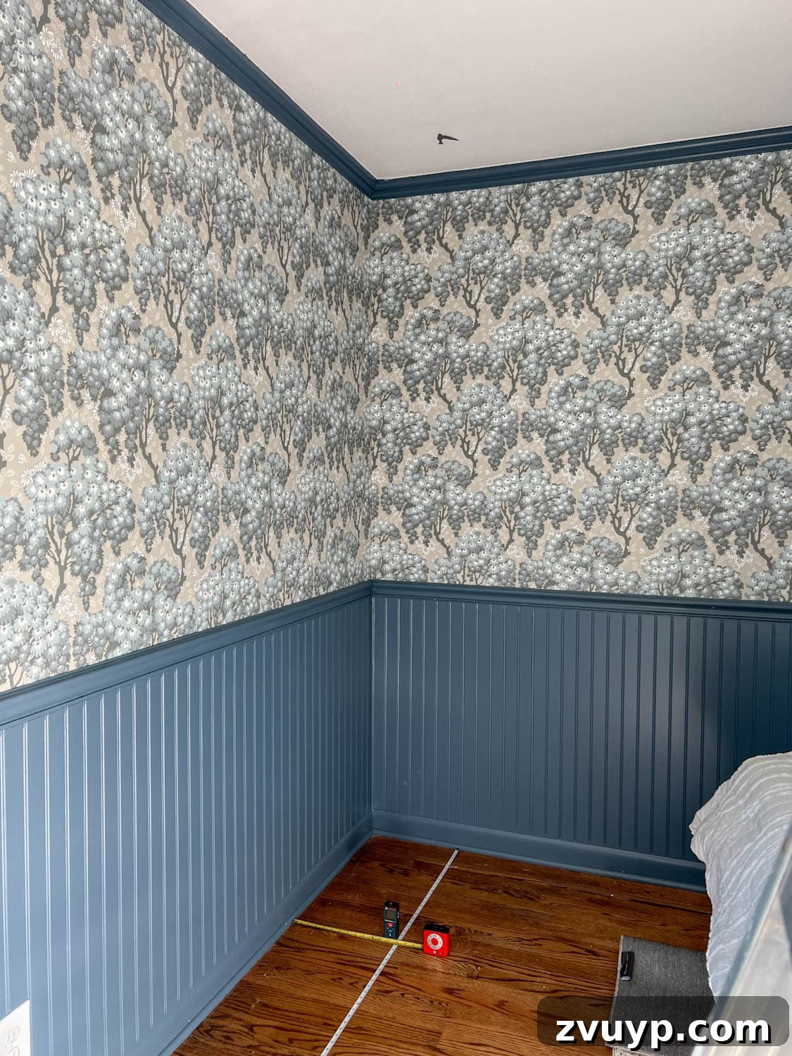 DIY Faux Block Print Ceiling Vinyl Decal Wallpaper 5 Measuring and marking a ceiling for faux wallpaper application, demonstrating the use of two tape measures and a laser level to create a block print grid.