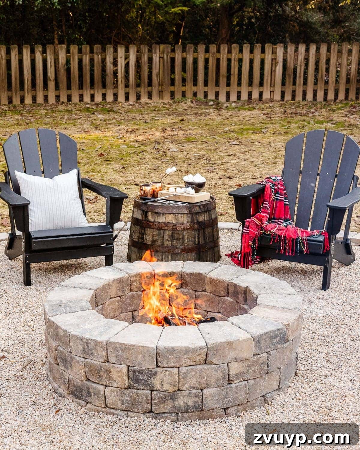 Effortless Backyard DIY: Create Your Dream Outdoor Space on a Budget 14 DIY stone fire pit in a backyard surrounded by Adirondack chairs, creating an inviting gathering space