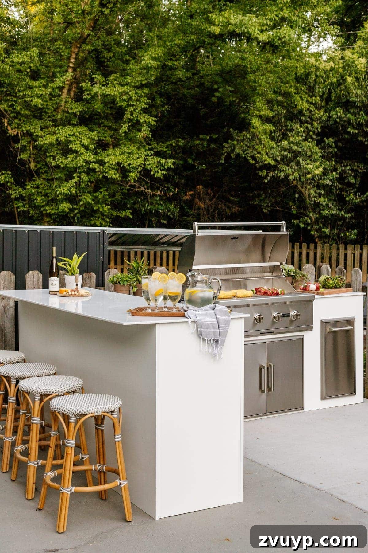 Effortless Backyard DIY: Create Your Dream Outdoor Space on a Budget 27 elegant white modular outdoor kitchen with French bistro stools, showcasing a modern and functional design