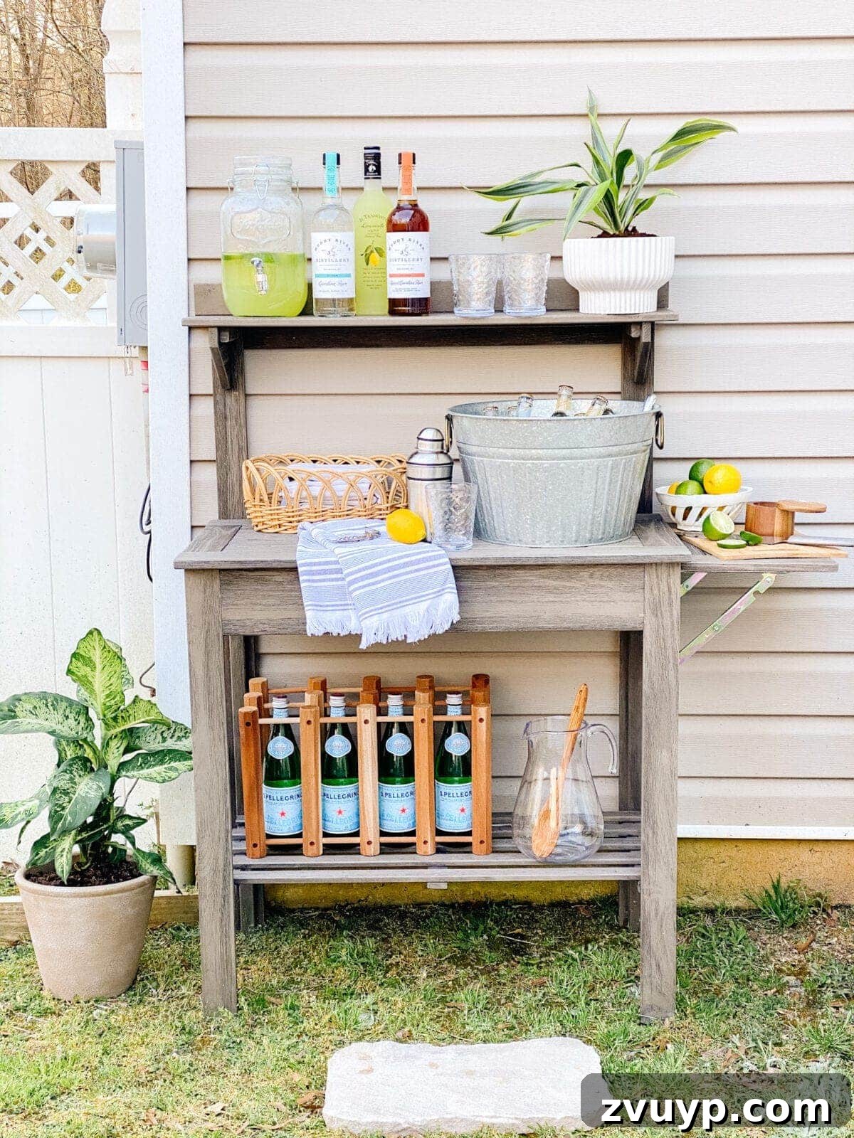 Effortless Backyard DIY: Create Your Dream Outdoor Space on a Budget 28 a potting bench repurposed as an outdoor bar, cleverly styled with thrifted items for serving drinks