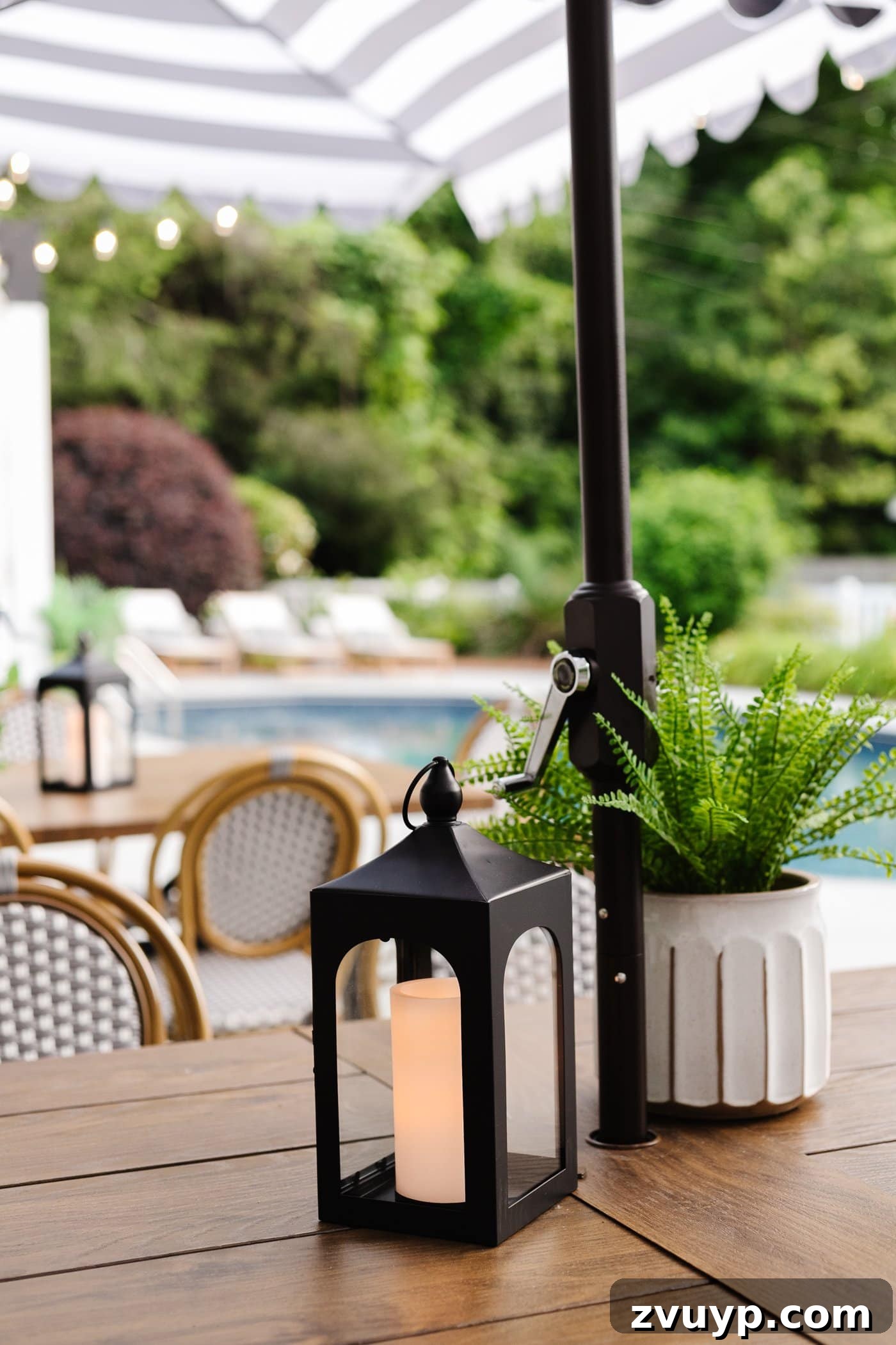 Effortless Backyard DIY: Create Your Dream Outdoor Space on a Budget 36 a fake outdoor plant in a planter on a patio table, offering maintenance-free greenery
