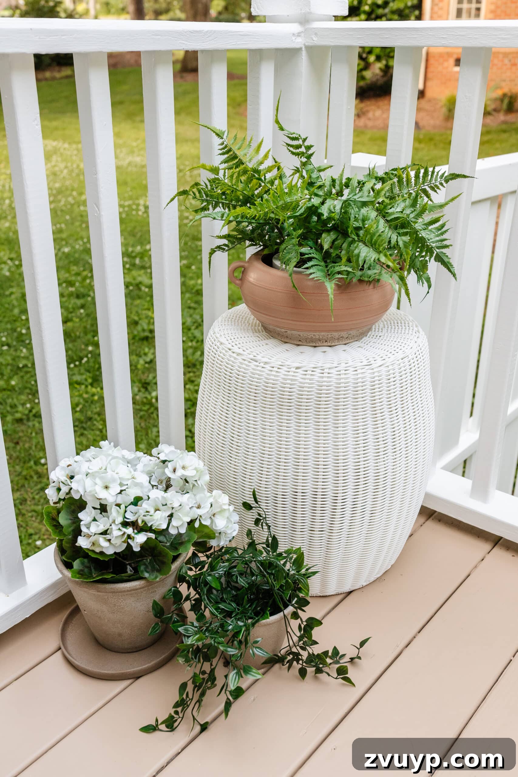 Effortless Backyard DIY: Create Your Dream Outdoor Space on a Budget 47 UV treated faux plants in planters around a back door, offering vibrant color without maintenance