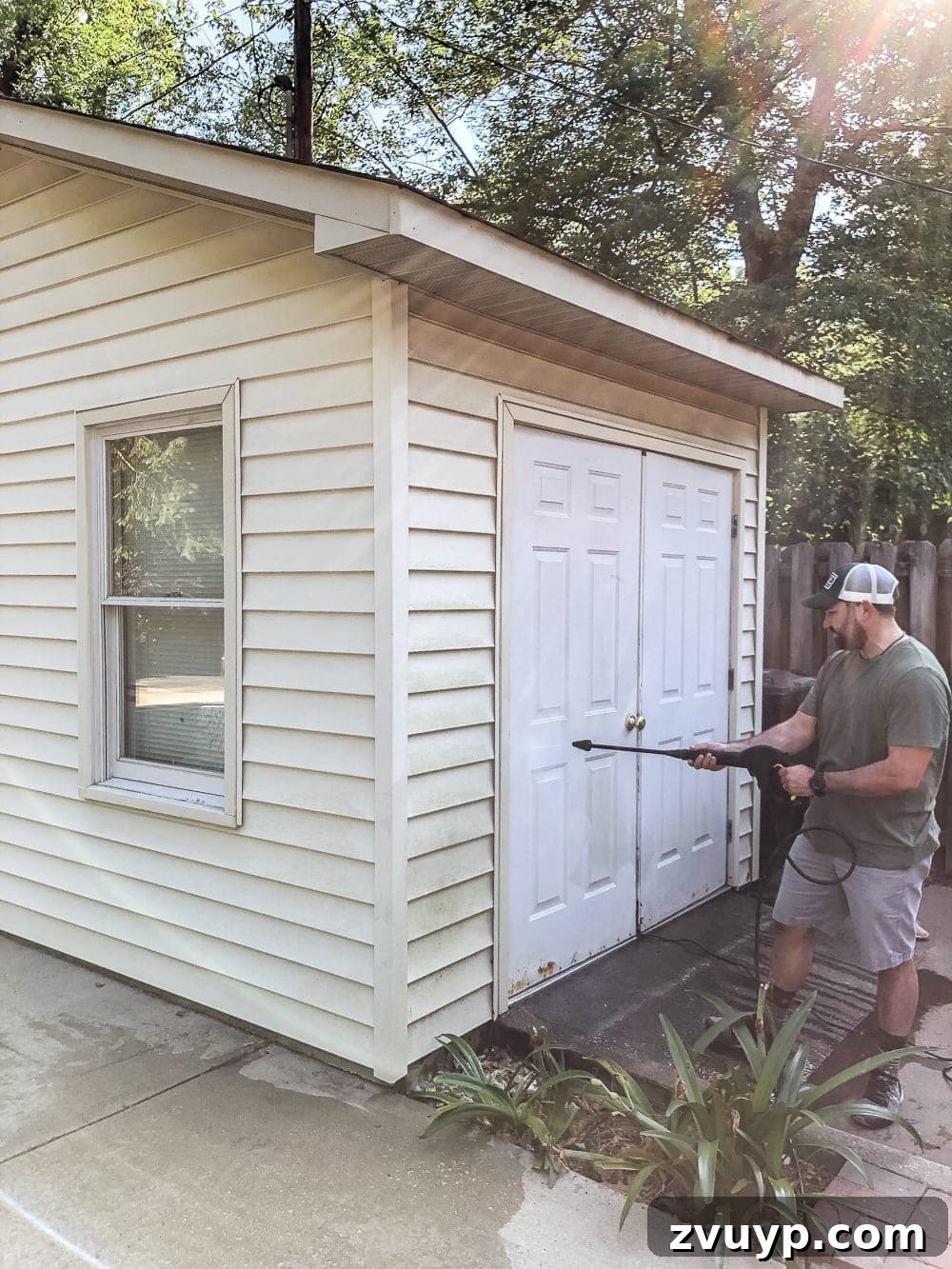Effortless Backyard DIY: Create Your Dream Outdoor Space on a Budget 8 faded vinyl siding on a backyard shed before painting, showing wear and tear