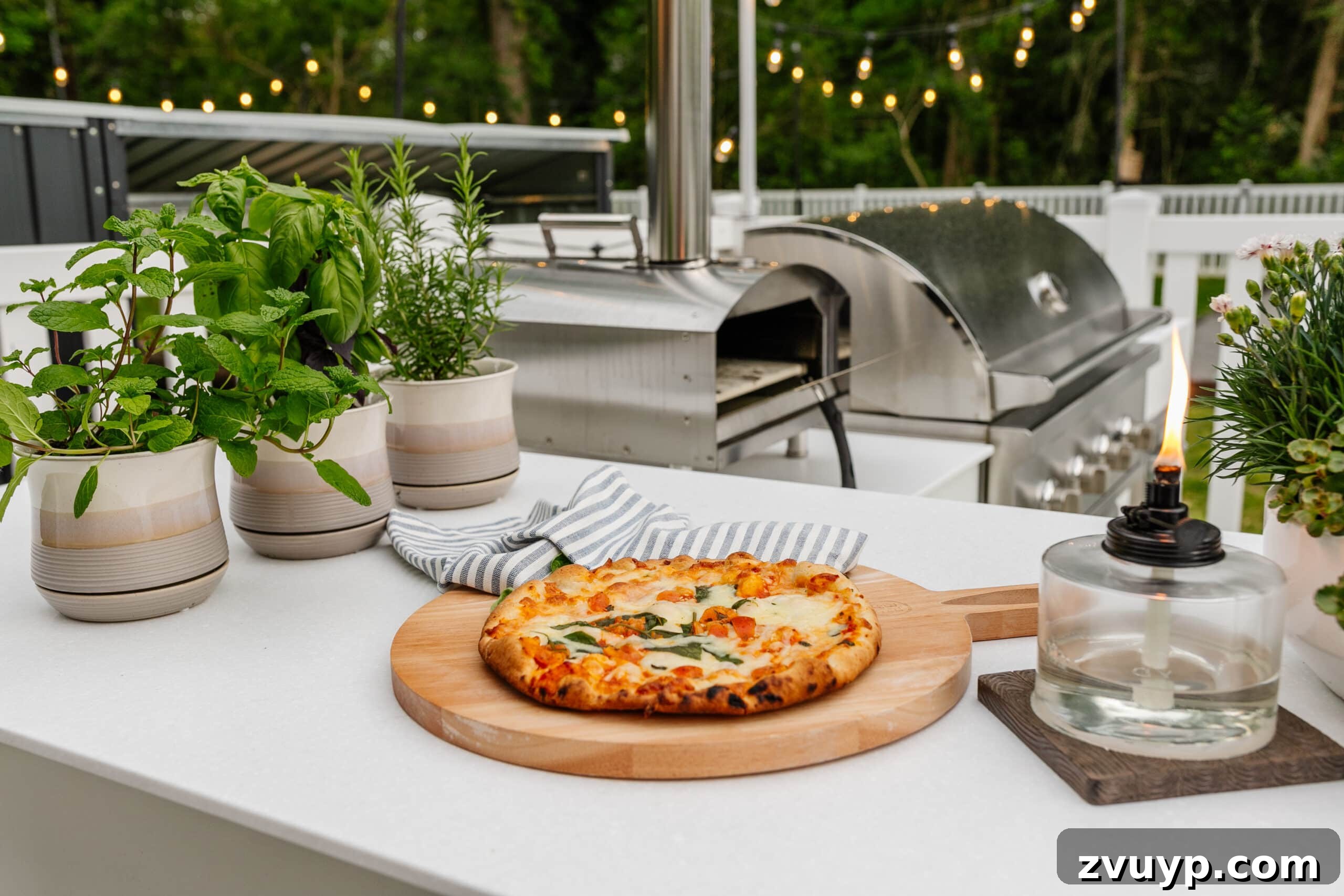 Effortless Spring Patio Refresh 13 backyard grill with outdoor pizza oven, tabletop tiki torch, and potted herbs