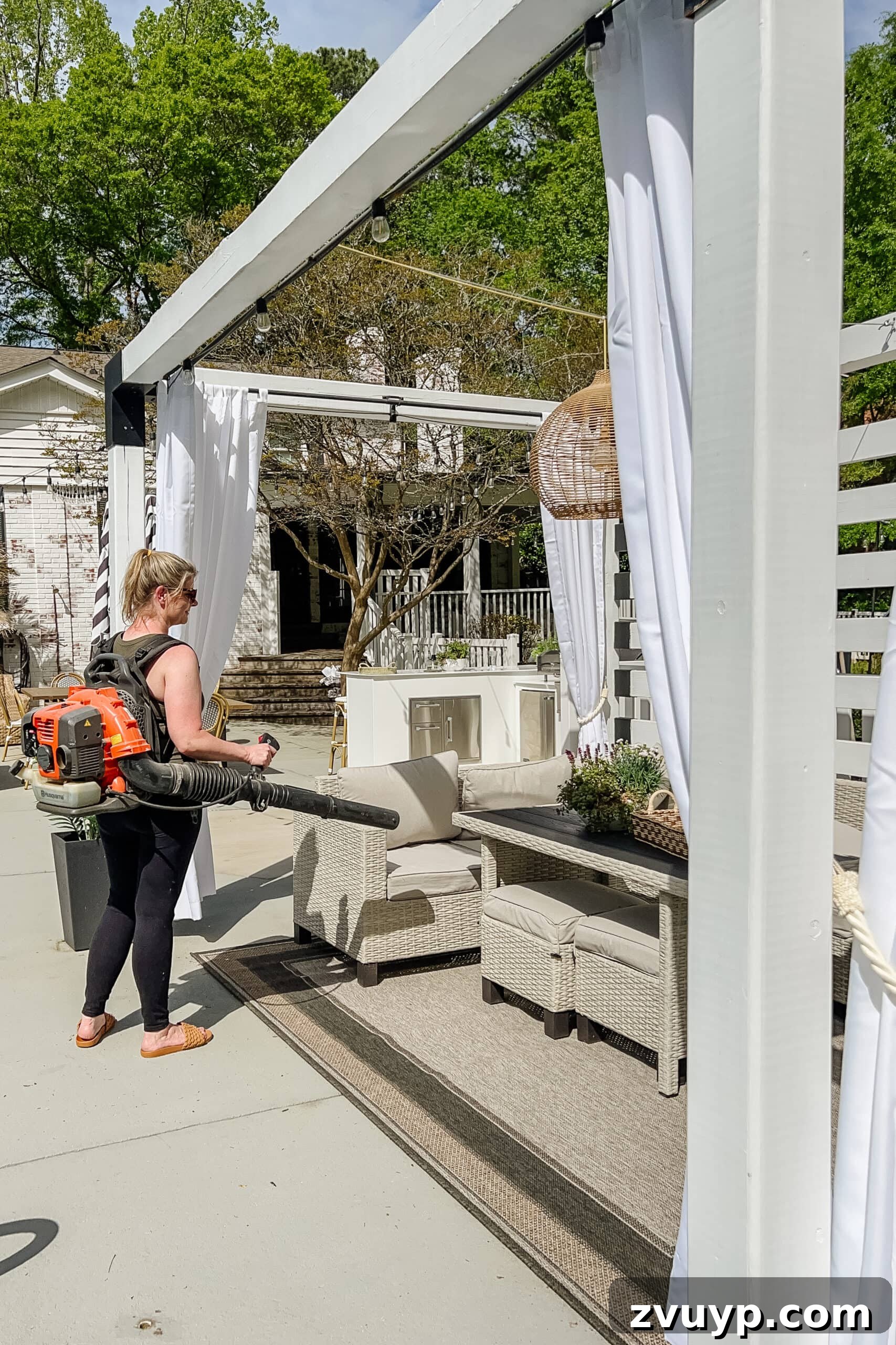 Effortless Spring Patio Refresh 16 cleaning debris on a patio using a leaf blower