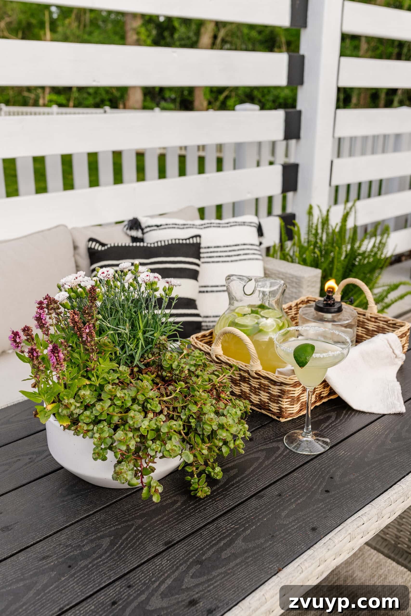 Effortless Spring Patio Refresh 17 patio dining table with tray, tabletop tiki torch, margarita pitcher, and potted plant