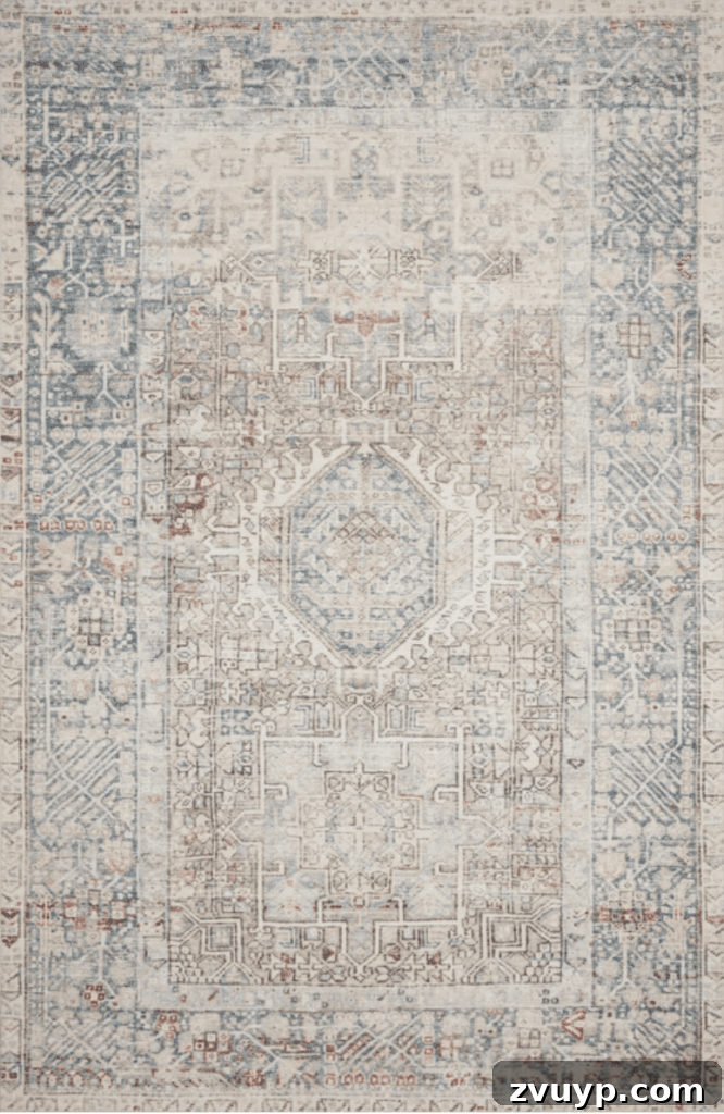 Timeless Traditional Rugs from Loloi 12 Close-up of the Chris Loves Julia x Loloi Jules Natural/Ocean Rug, showcasing its beautiful blend of blush pinks and blues, perfect for a coastal or feminine aesthetic.