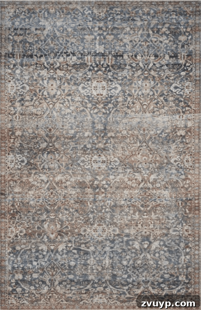Timeless Traditional Rugs from Loloi 8 Detailed view of the Chris Loves Julia x Loloi Jules Denim/Spice Rug, showcasing its intricate pattern and resilient design perfect for high-traffic areas.