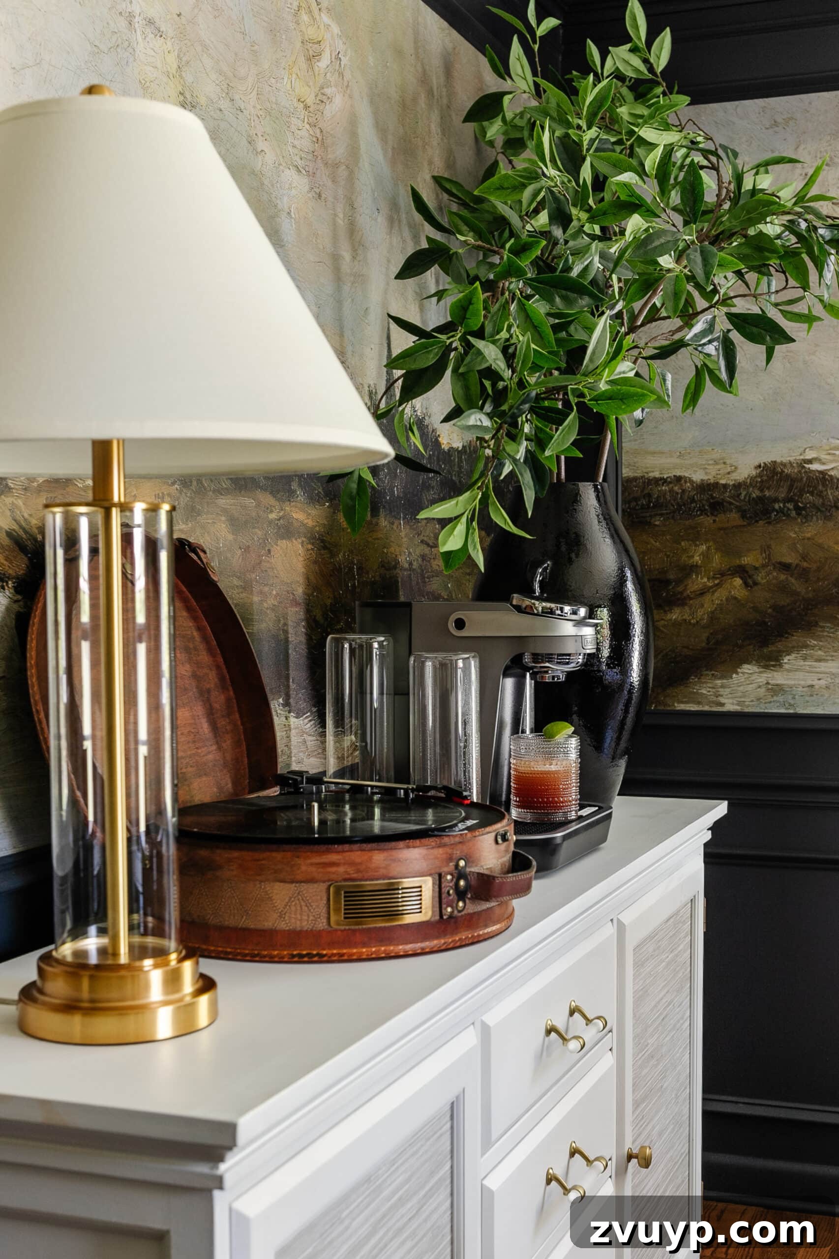 Bartesian Cocktail Maker Review: Is It Worth It? 6 drink machine on a dining room buffet sideboard with lamp, record player, and vase of branches