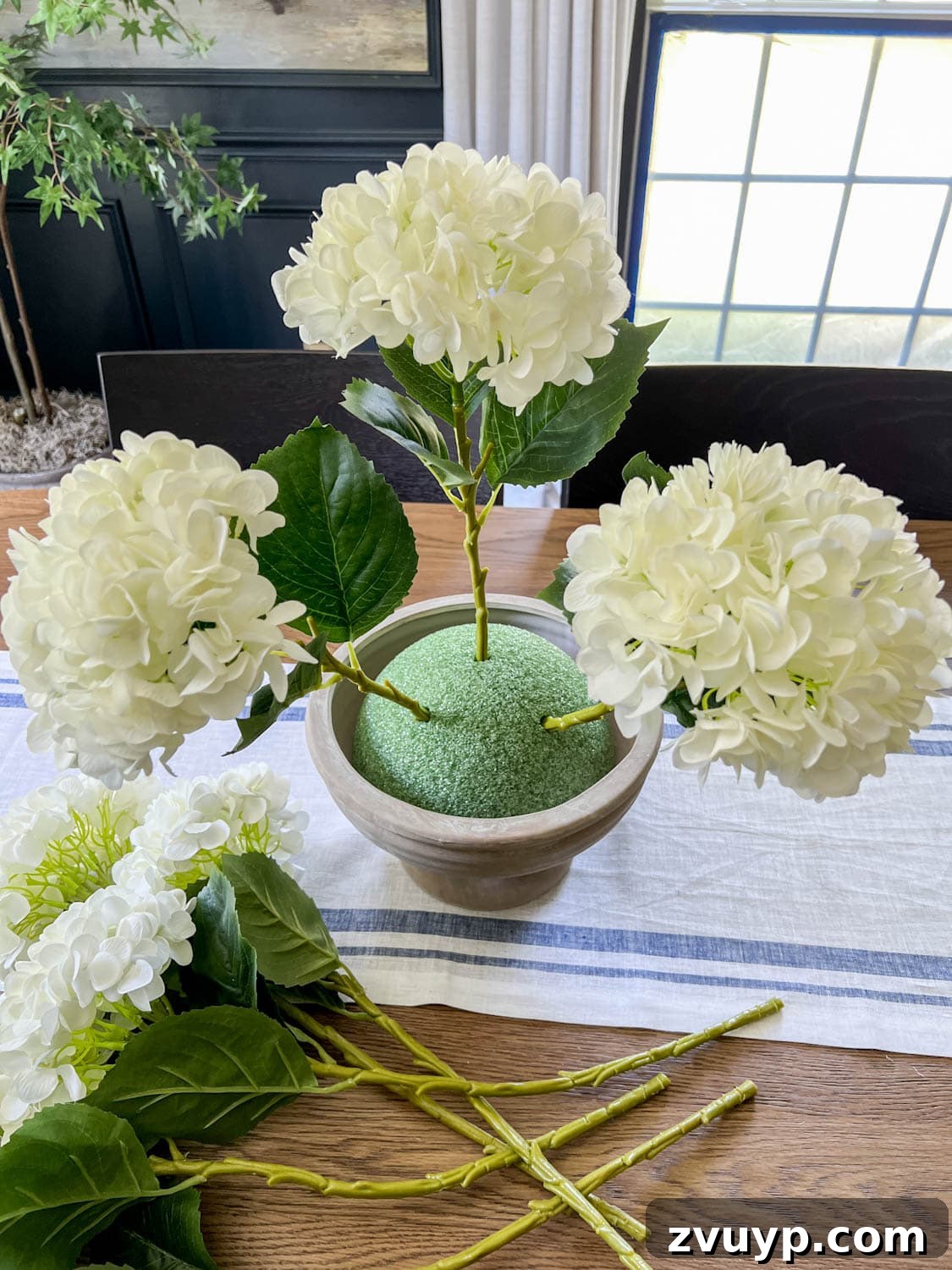 Effortless Charm DIY Faux Flower Creations 11 placing faux flowers in odd numbers to arrange in foam to make wedding altar flowers