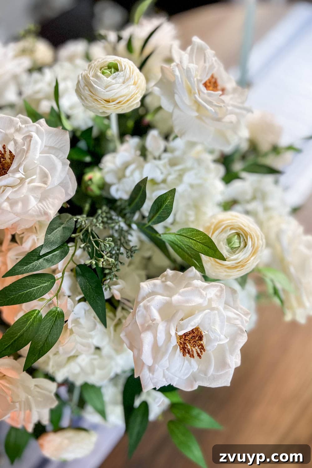 Effortless Charm DIY Faux Flower Creations 16 fake flower arrangement centerpiece using faux hydrangeas, roses, ranunculus, ruscus, and eucalyptus