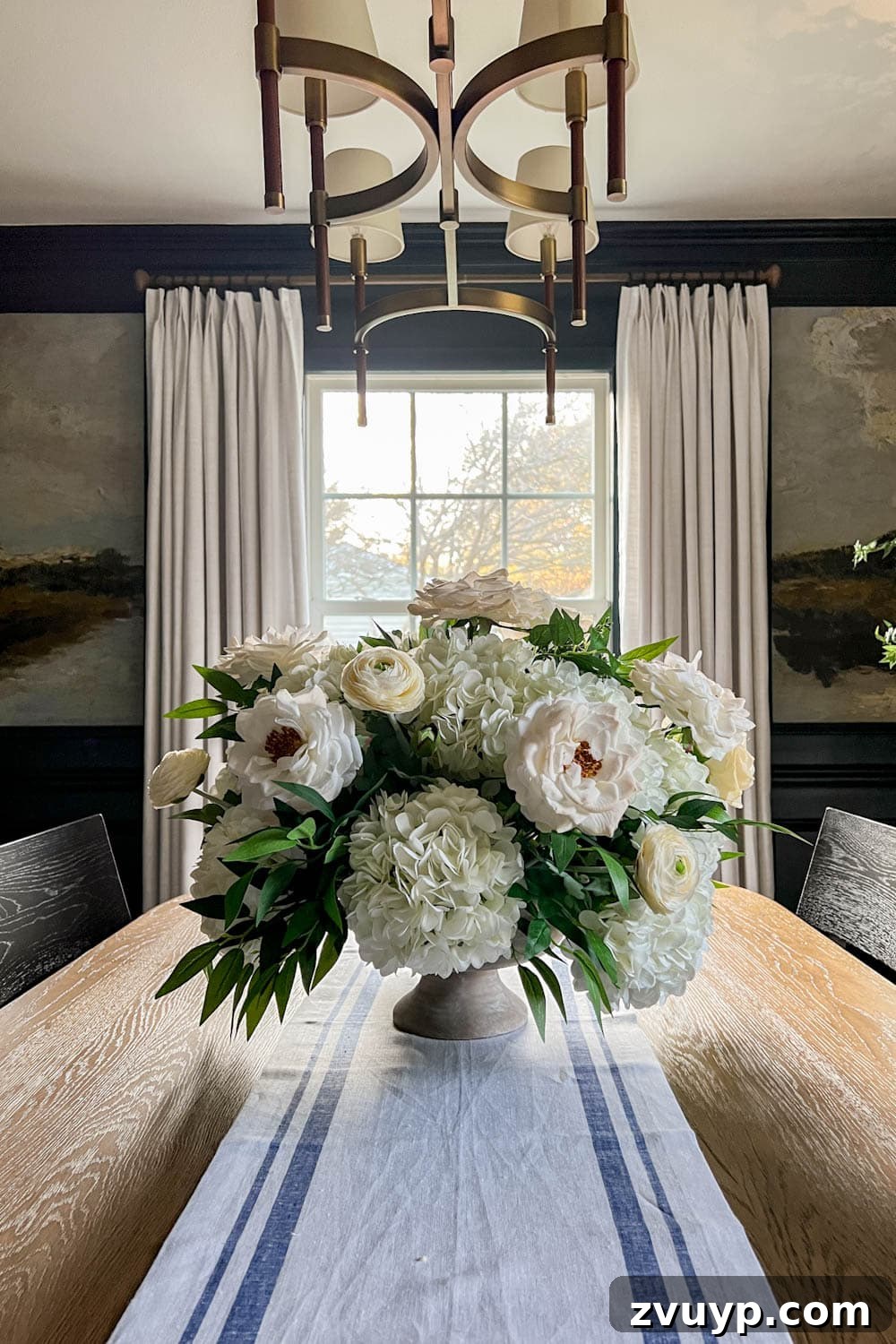 Effortless Charm DIY Faux Flower Creations 17 white flower arrangement wedding centerpiece with fake hydrangeas, roses, ranunculus, ruscus, and eucalyptus