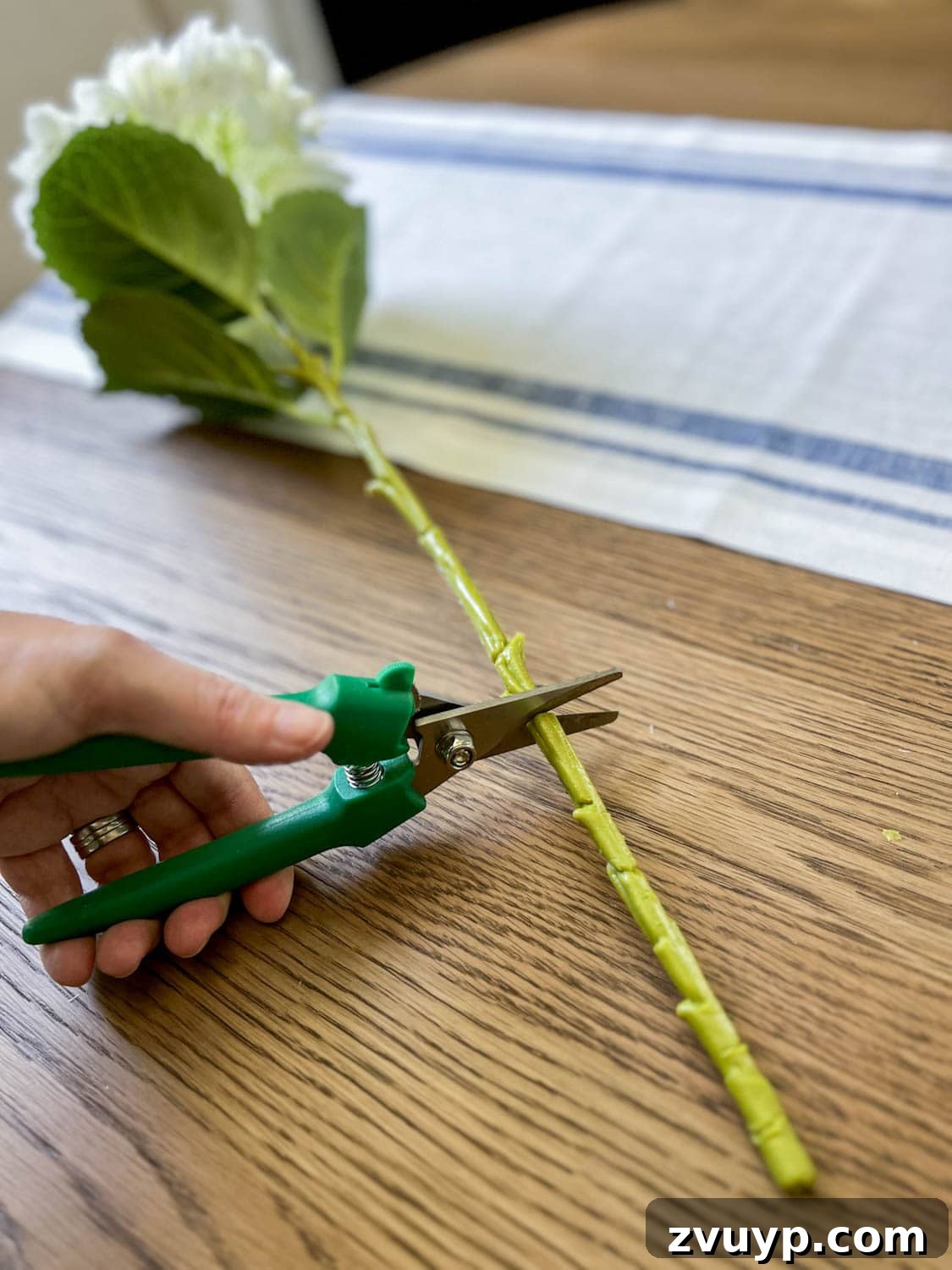 Effortless Charm DIY Faux Flower Creations 8 cutting a faux flower for a floral arrangement