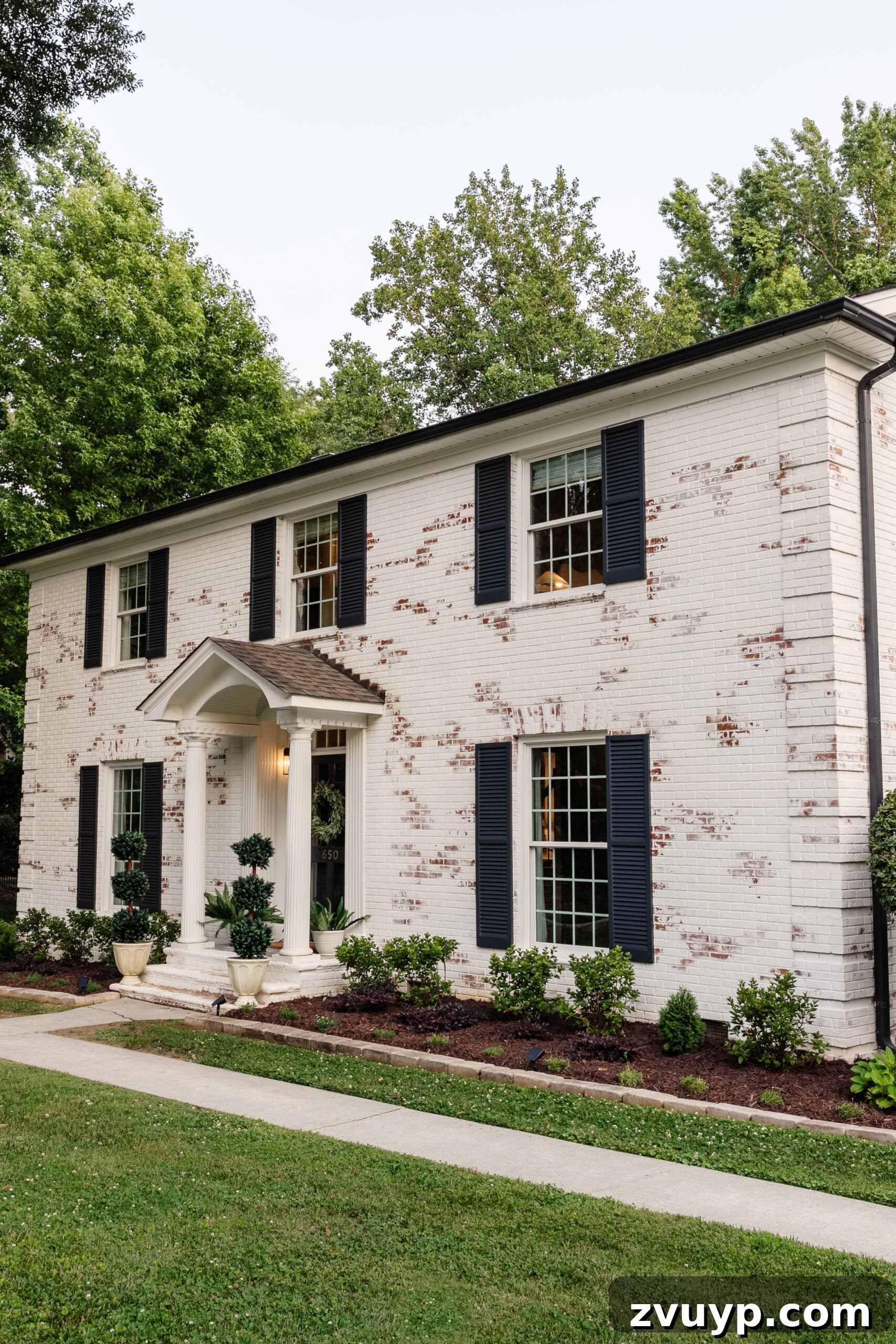Pristine Limewashed Brick A Comprehensive Care Guide 18 Refreshed limewashed brick colonial house exterior with meticulously maintained flower beds