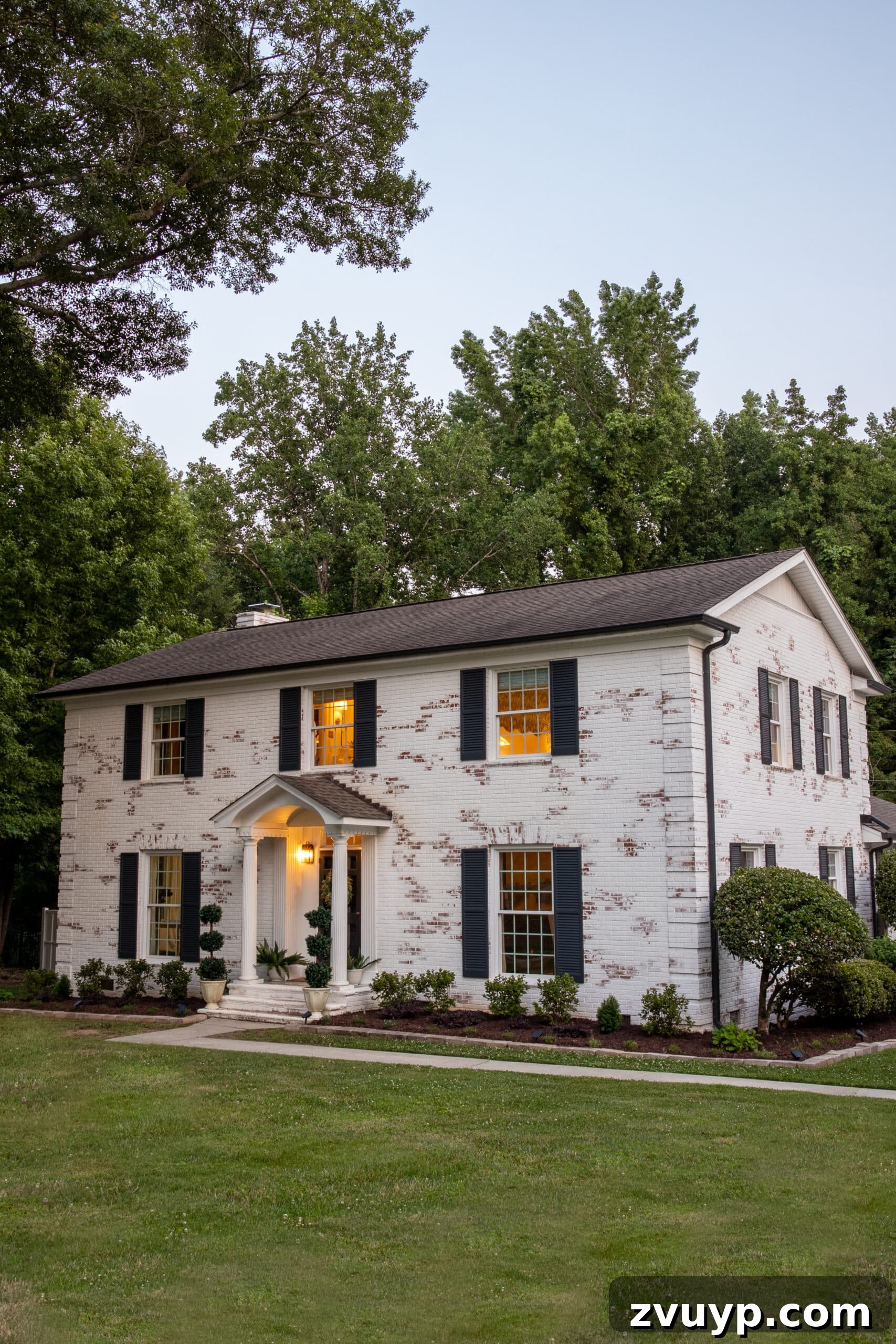 Pristine Limewashed Brick A Comprehensive Care Guide 21 Detailed view of a white limewashed brick colonial house, highlighting the beautiful Romabio limewash finish
