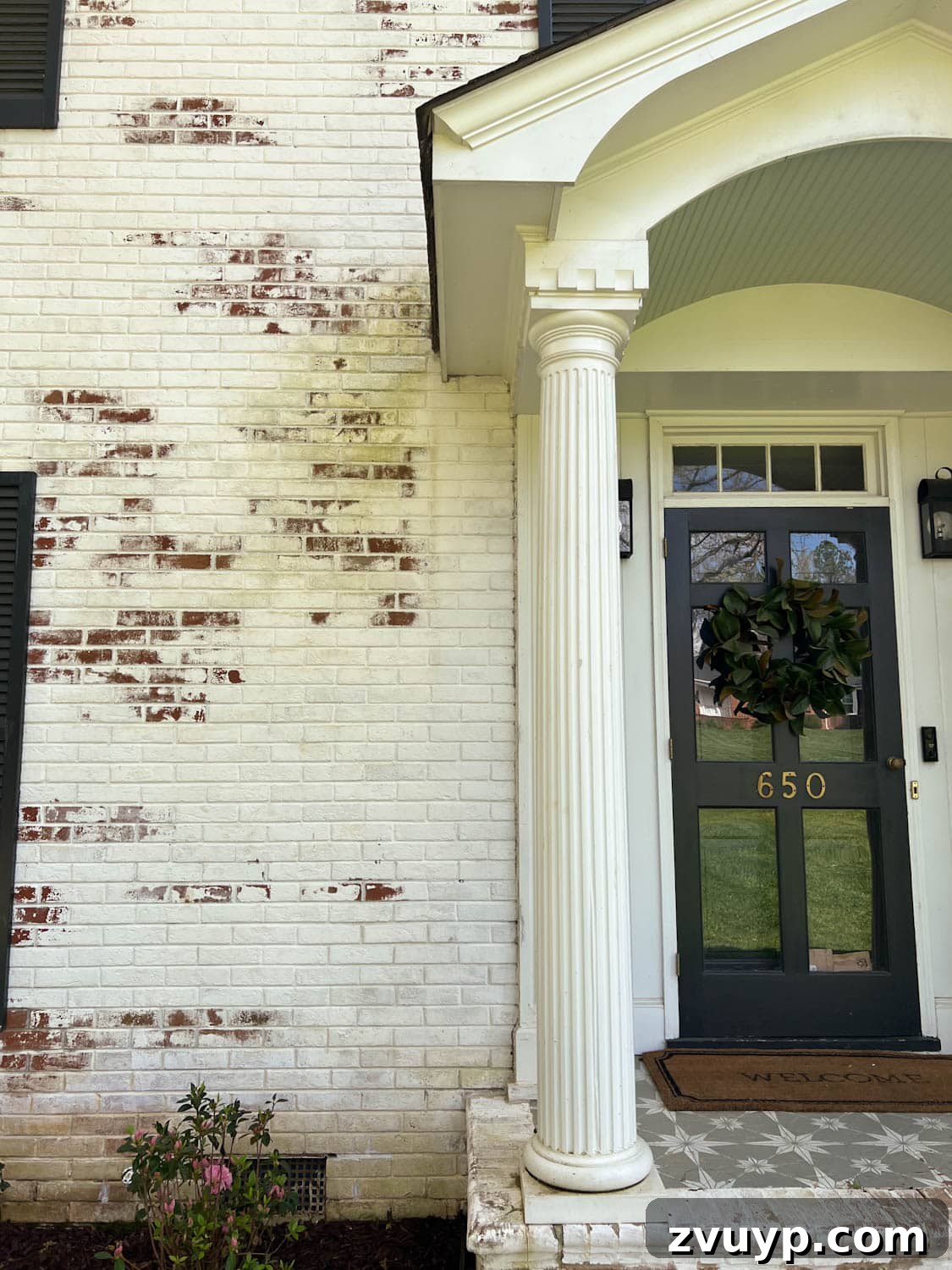 Pristine Limewashed Brick A Comprehensive Care Guide 4 Dirty limewashed brick before cleaning, showing signs of wear and grime near a porch stoop