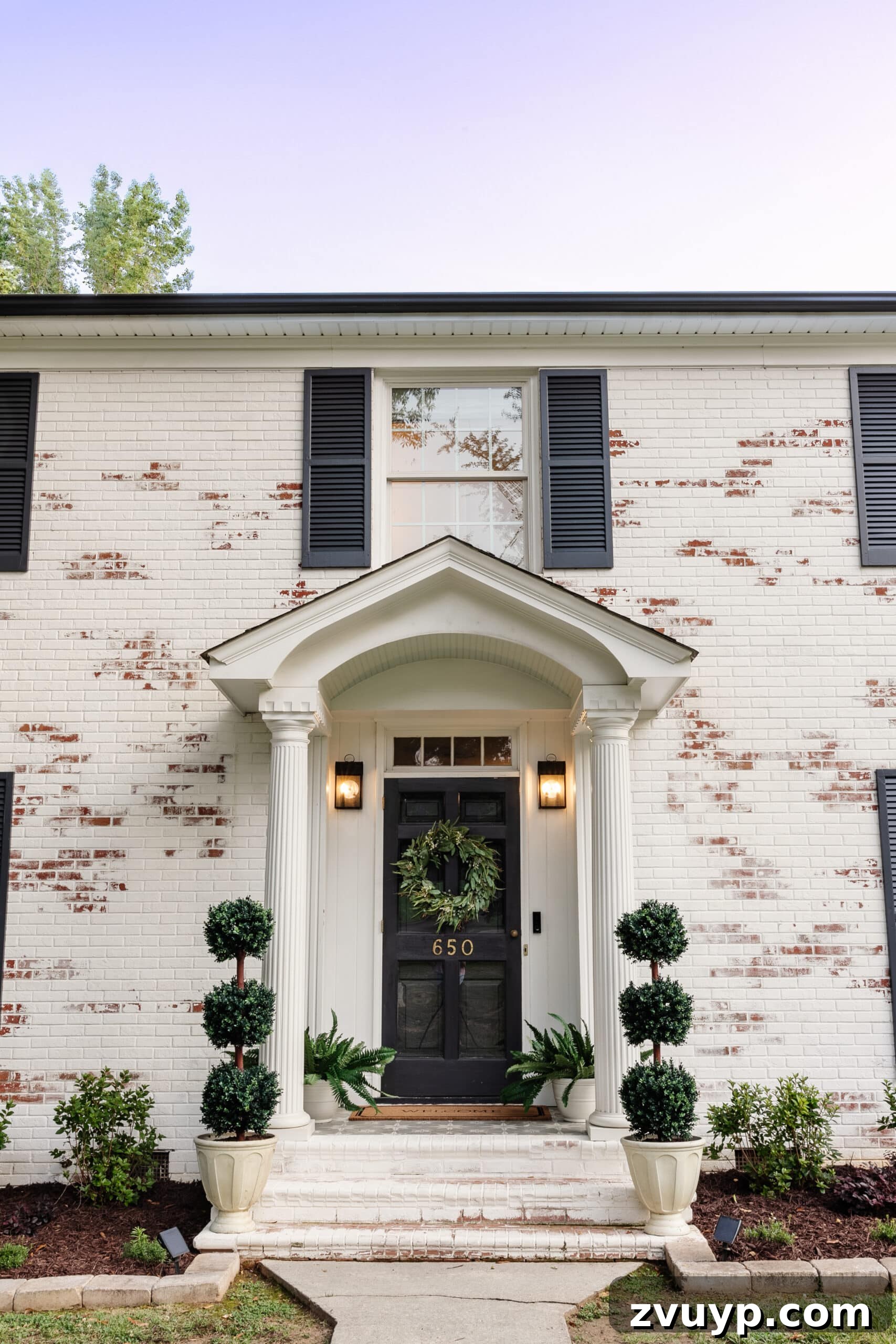 Pristine Limewashed Brick A Comprehensive Care Guide 5 Inviting front porch stoop on a colonial house, adorned with topiaries, ferns, and a decorative wreath