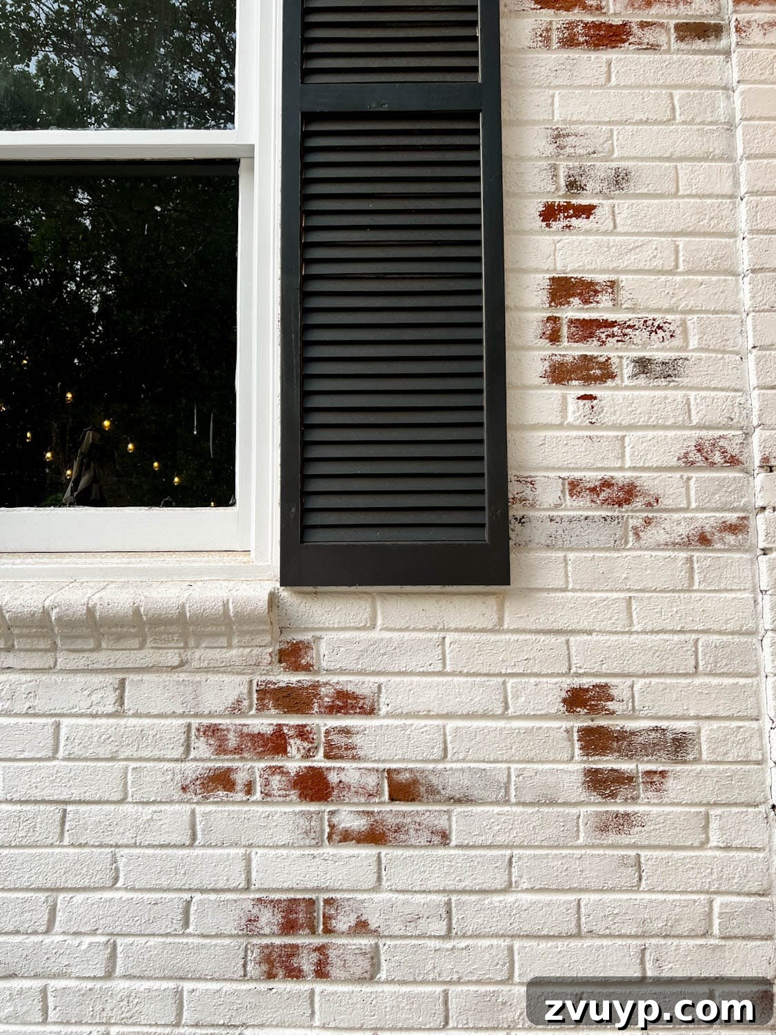 Pristine Limewashed Brick A Comprehensive Care Guide 6 Elegant white limewashed brick exterior contrasted with classic black shutters