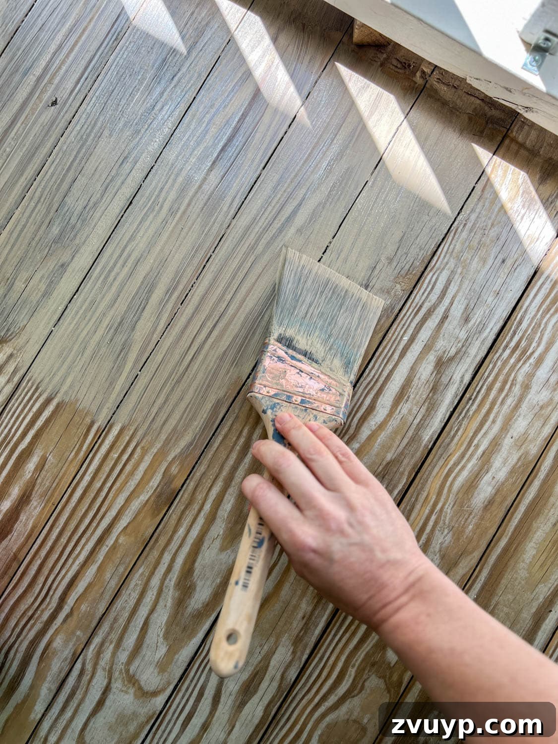 Selecting the Perfect Deck Stain for a Neutral Driftwood Finish 7 applying Behr Taupe Stain to remove yellow tone from wood deck