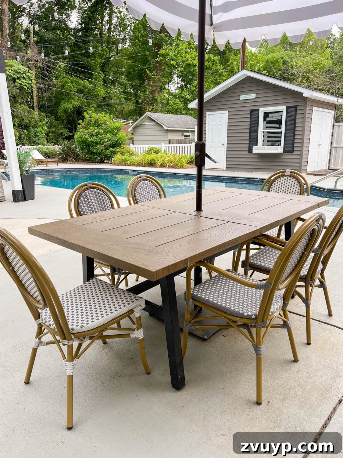 Walmart Patio Furniture Two Year Verdict 14 outdoor table beside a pool in a backyard with french bistro chairs