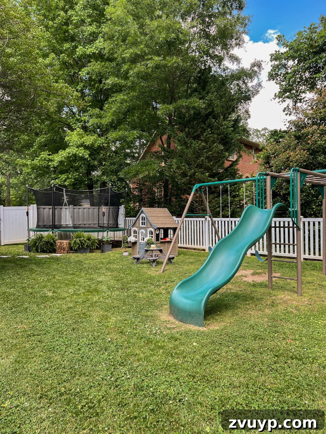 Transform Your Side Yard: 8 Play Area & Trampoline Design Ideas 12 side yard play area for kids with trampoline, outdoor playhouse, and swing set, creating a comprehensive play zone