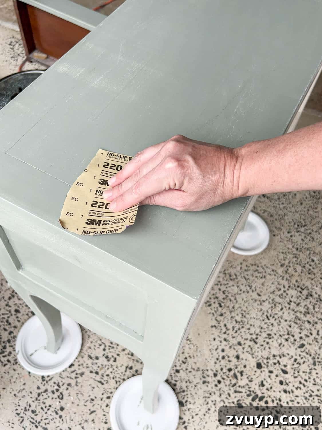 DIY Bedside Table Refresh: Secrets to Smooth Gloss Paint 11 sanding a nightstand for a smooth painted finish after the first coat of gloss paint