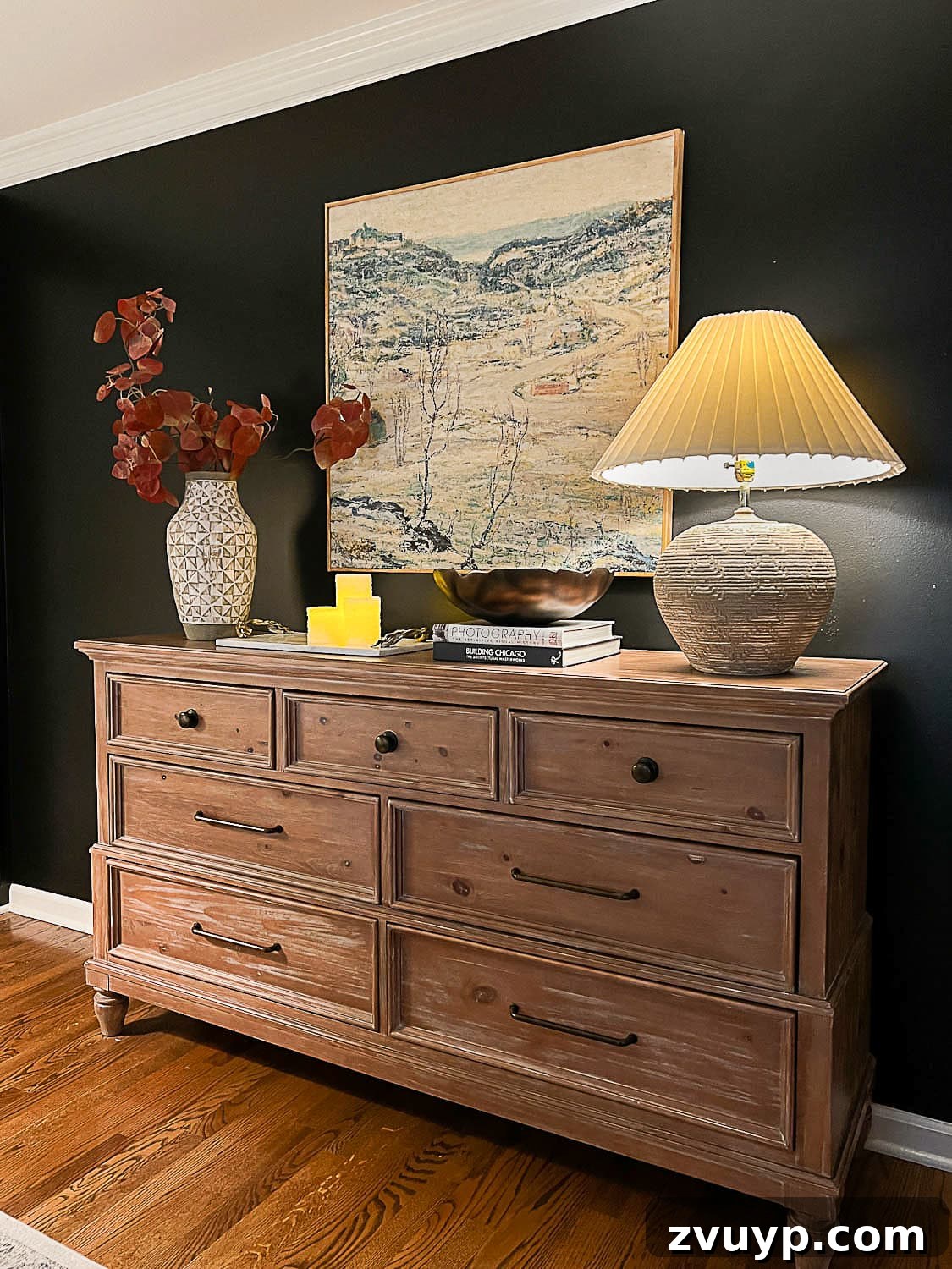 Hang Like a Pro: Avoid These Picture Frame Mistakes 14 Beautiful DIY art perfectly scaled and hung above a dresser in a cozy bedroom setting.