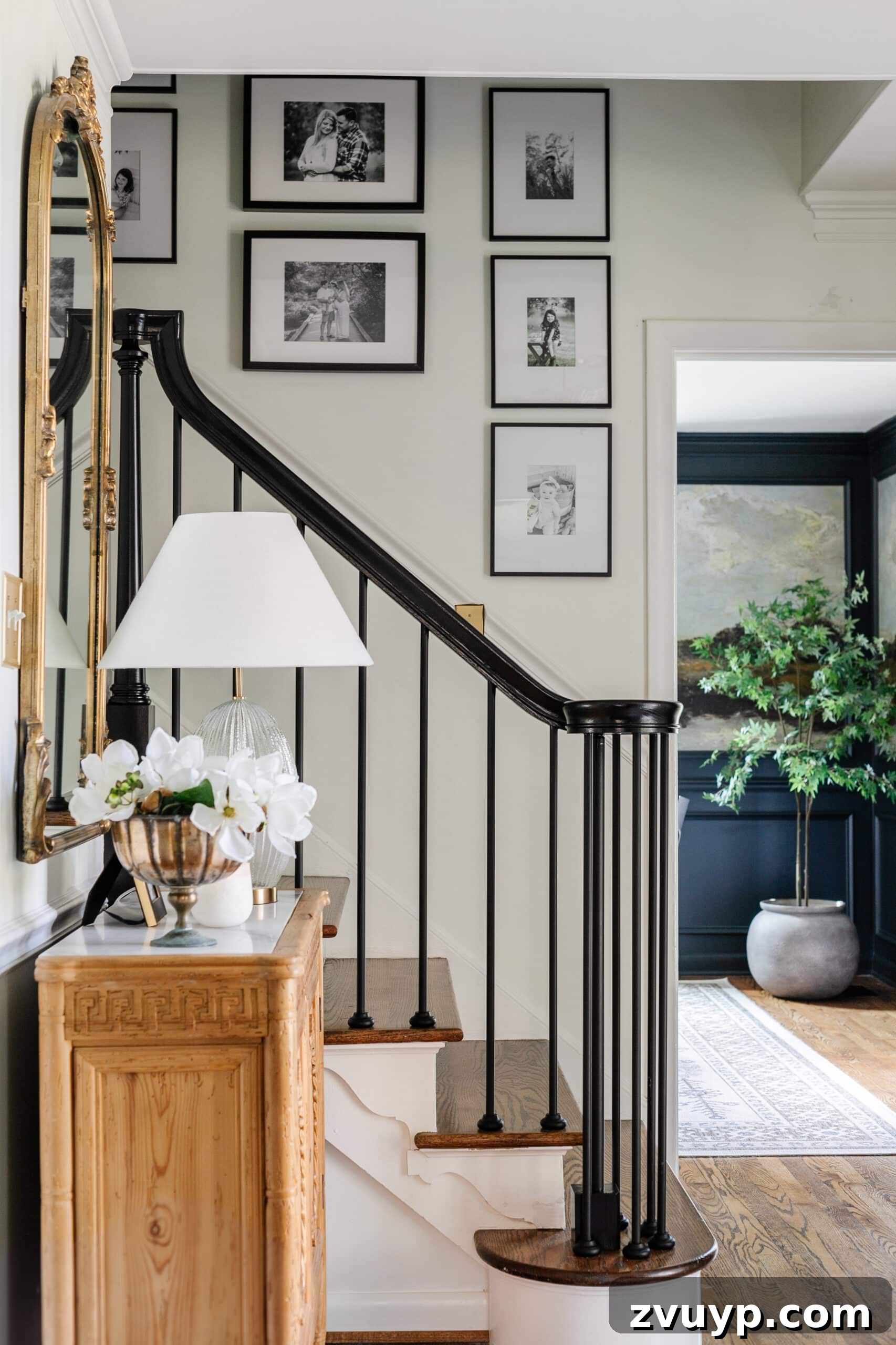 Hang Like a Pro: Avoid These Picture Frame Mistakes 3 Elegant black and white gallery wall ascending a staircase, showcasing perfect placement.