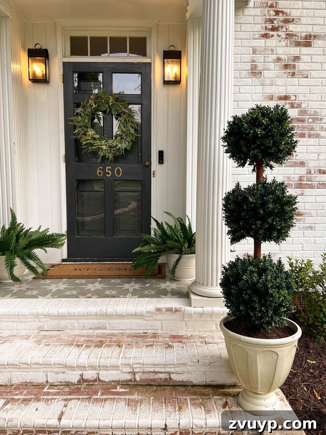 Lifelike Faux Plants for Effortless Porch Planters 3 artificial boxwood topiaries on a front porch