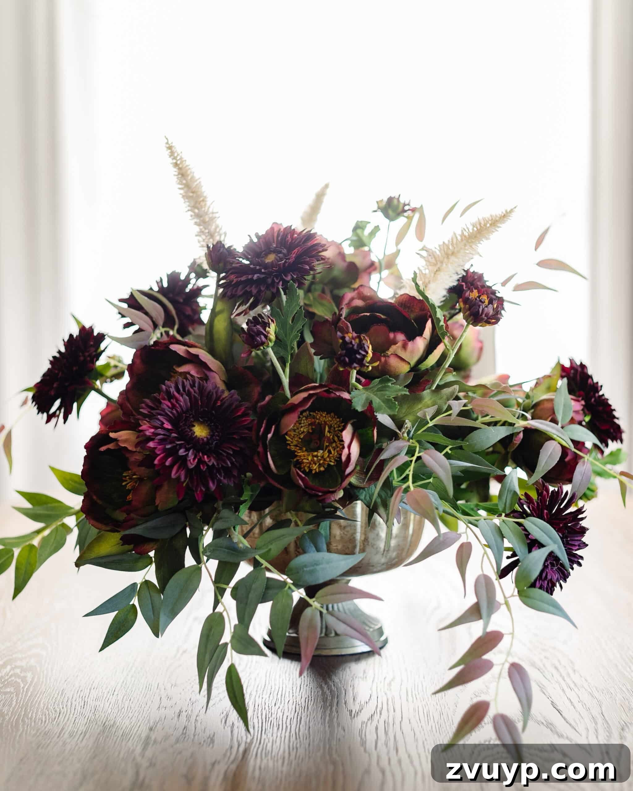 Autumn Blooms: Simple DIY Floral Arrangements 16 Beautiful fall floral centerpiece featuring burgundy and purple flowers, ready for display