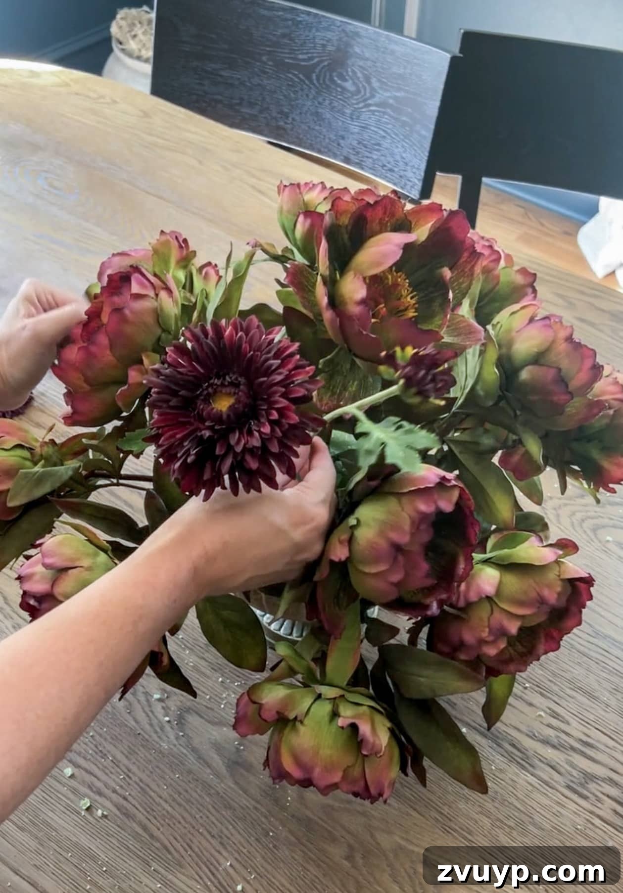Autumn Blooms: Simple DIY Floral Arrangements 10 Filling in a fall flower arrangement with elegant burgundy mums for added depth