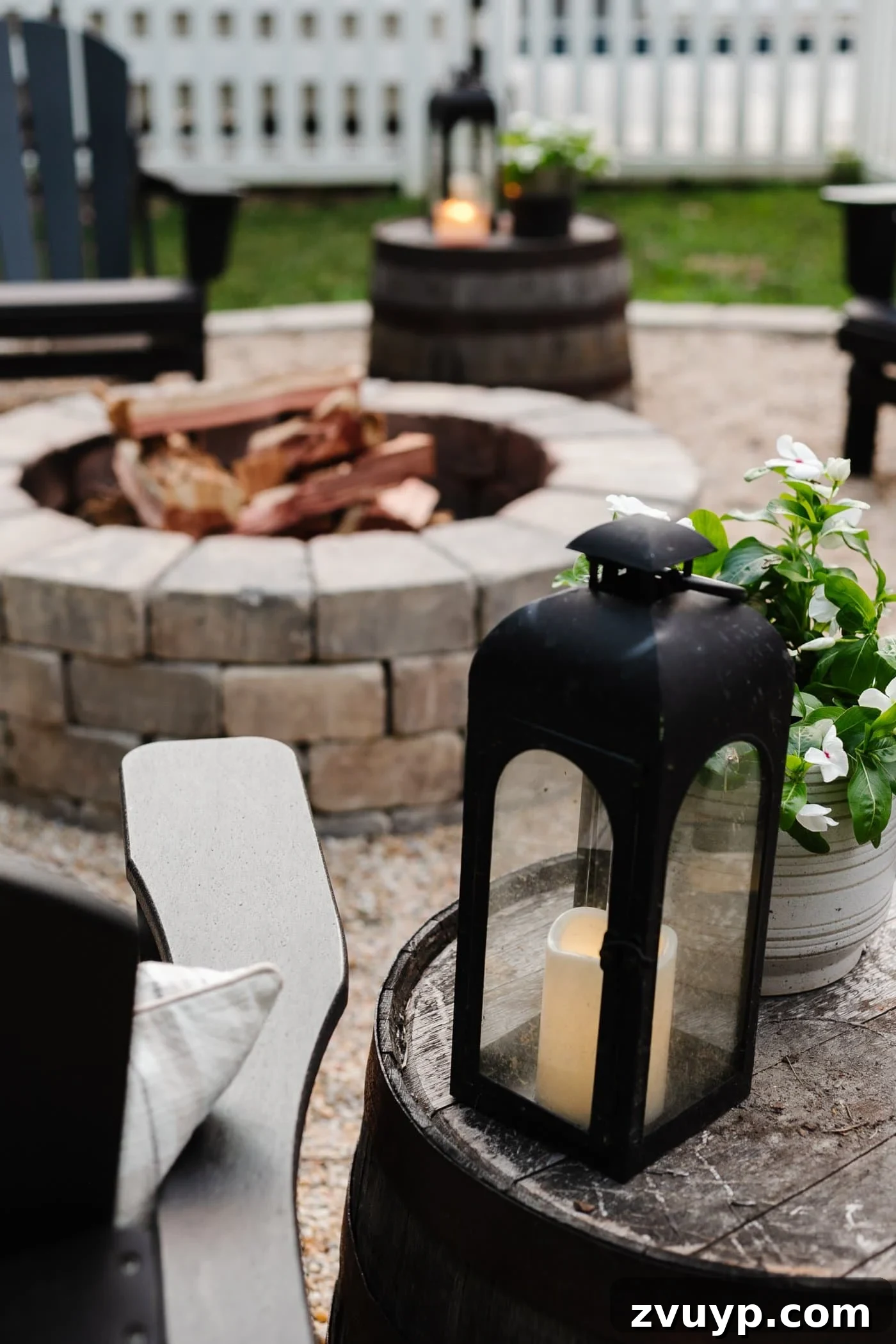 Fireside Fantasies: How to Host a Bonfire Party They'll Never Forget 7 lantern beside a backyard fire pit