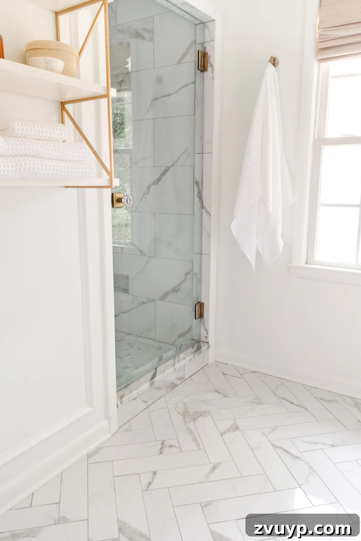 Small Bathroom Illusions: Design Tips for a Spacious Feel 13 Bathroom with herringbone patterned marble effect tiles