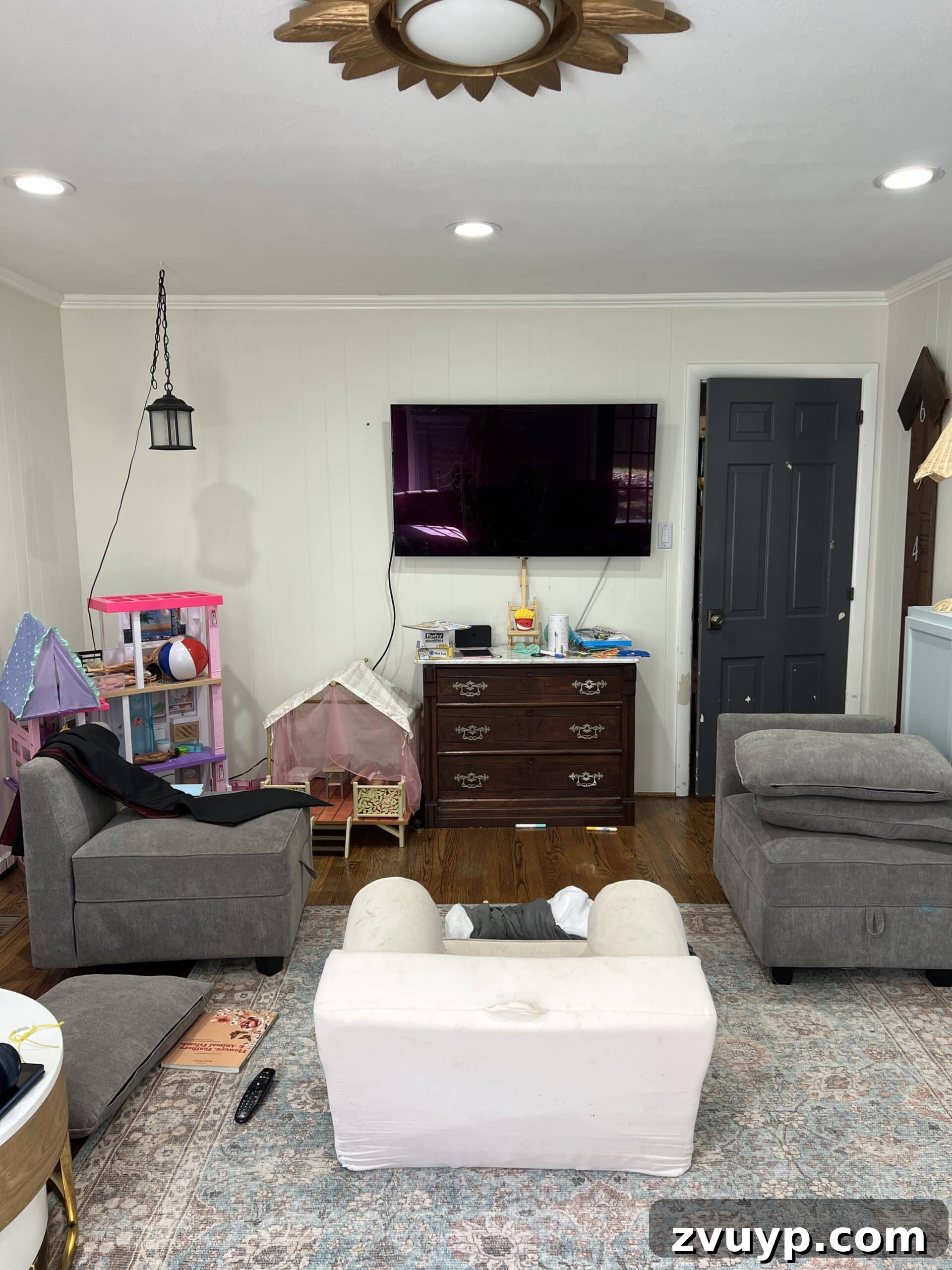 Your Next Media Room Makeover: Smart Storage for a Clutter-Free Entertainment Hub 11 A before photo of a playroom wall, currently housing various cabinets, highlighting the potential for conversion into a functional media room with built-in desks.