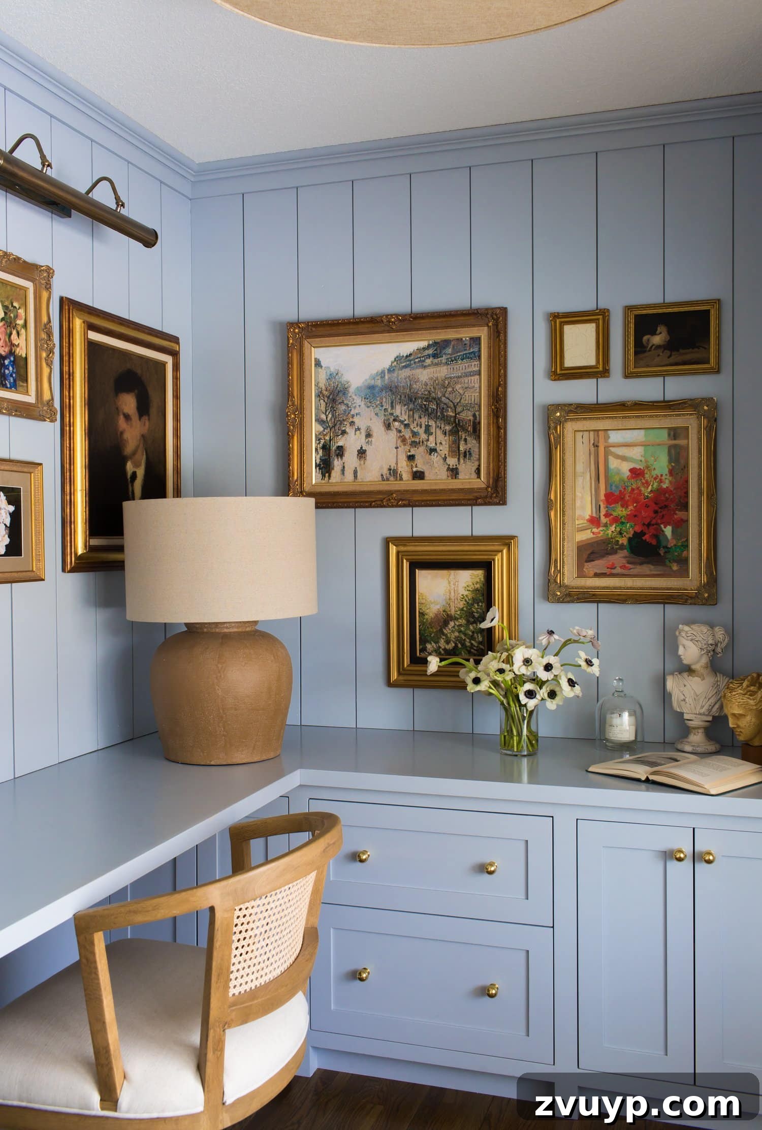 Your Next Media Room Makeover: Smart Storage for a Clutter-Free Entertainment Hub 12 A beautifully designed wall featuring custom built-in desks with a television integrated into a gallery wall, surrounded by framed art, creating a sophisticated and multi-functional workspace.