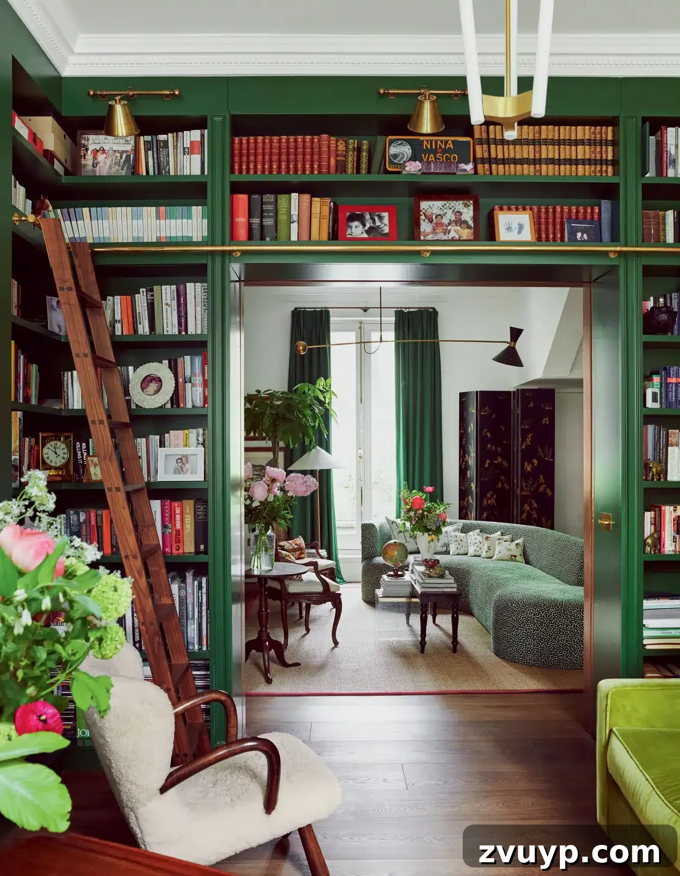 Your Next Media Room Makeover: Smart Storage for a Clutter-Free Entertainment Hub 8 An elegant space featuring built-in bookcases surrounding a doorway, extending overhead to maximize vertical storage and create a seamless, integrated library feel in a sophisticated room.