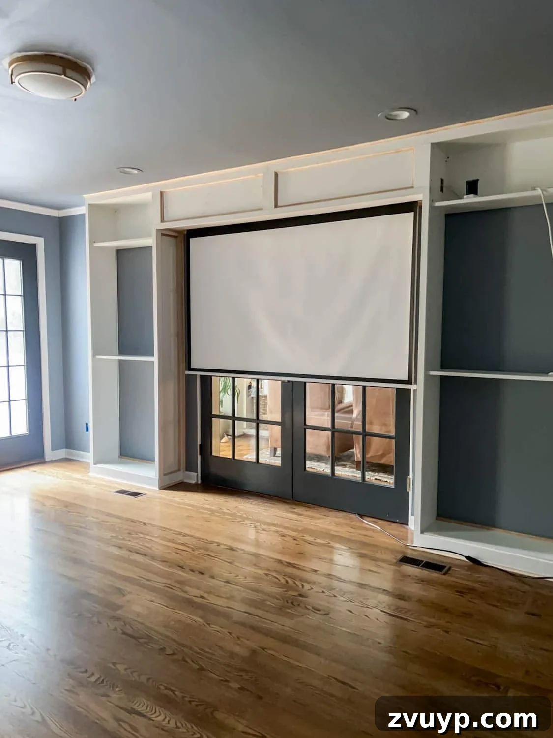 The Ultimate Hidden Projector Screen IKEA Hack 2 Hidden built-in projector screen seamlessly integrated into a stylish media room with IKEA shelves