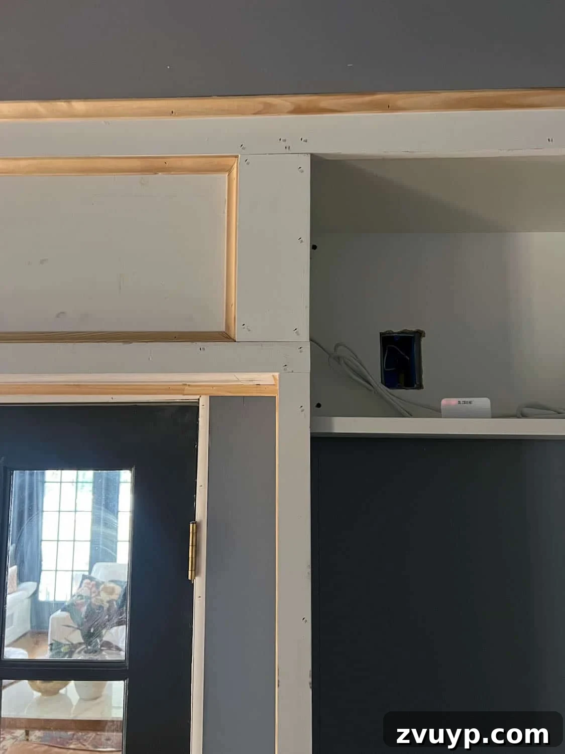 The Ultimate Hidden Projector Screen IKEA Hack 13 Hidden electric projector screen setup, showing discreet outlet access for power and remote control