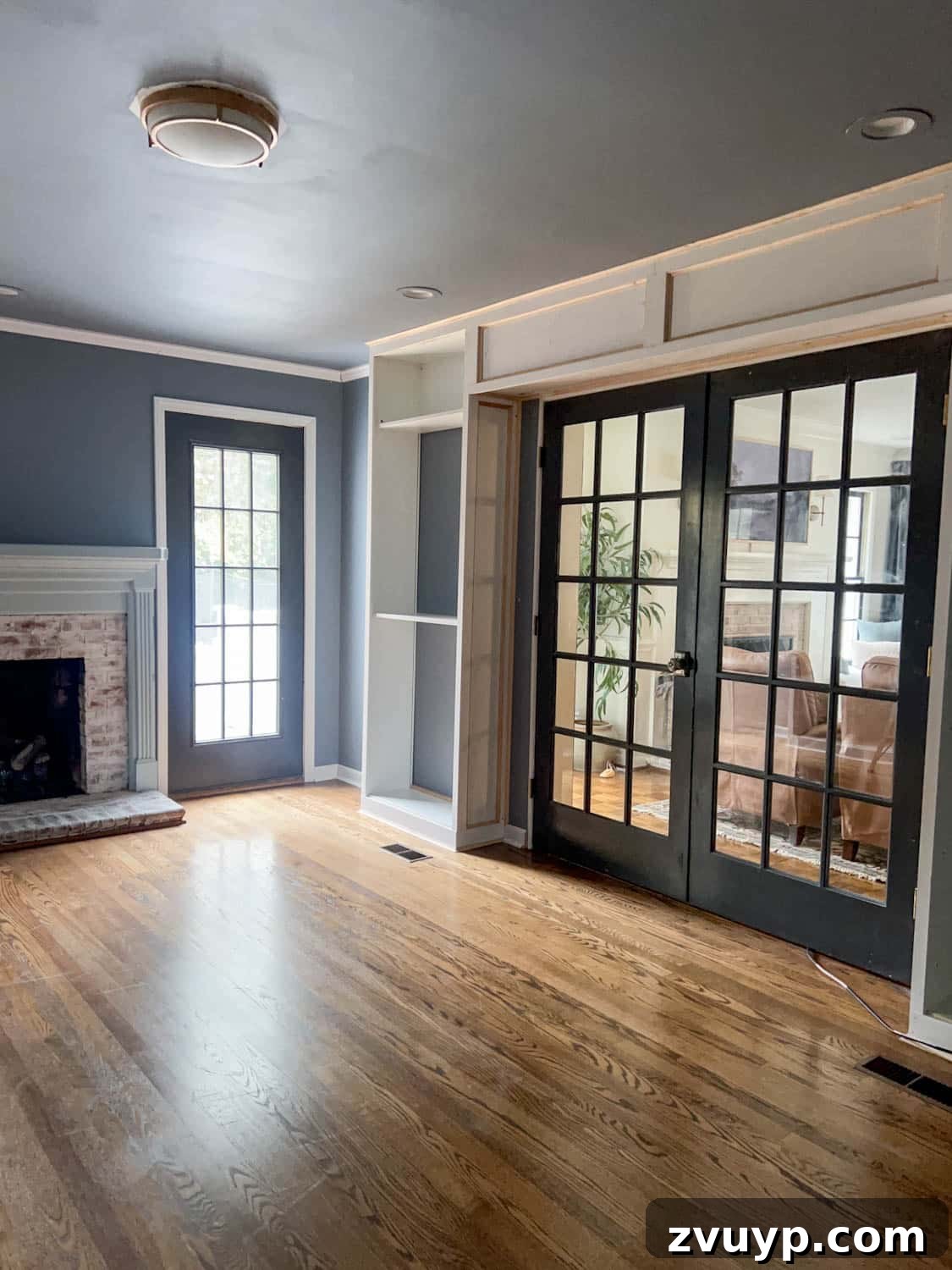 The Ultimate Hidden Projector Screen IKEA Hack 16 French doors elegantly framed by IKEA Billy bookcases, integrated into a stylish home interior