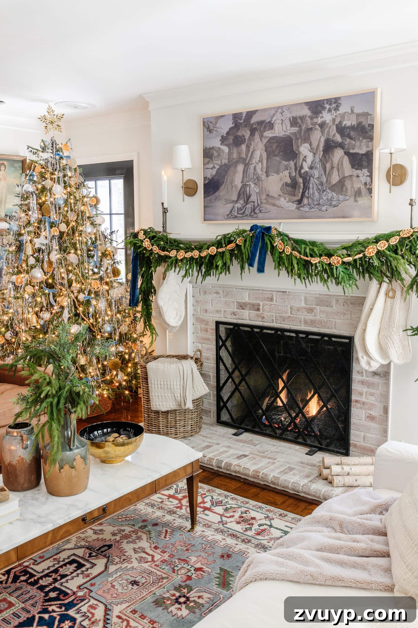 Craft Your Own Stunning Christmas Mantel Garland 11 Christmas fireplace decorated with layered pine garland, luxurious blue velvet ribbon, juniper sprigs, and dried orange slices.