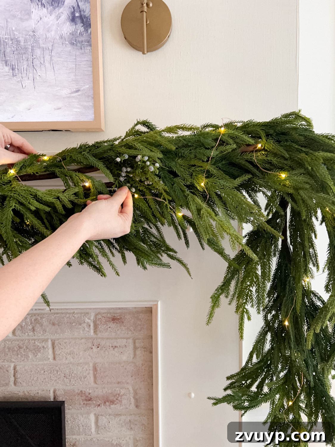 Craft Your Own Stunning Christmas Mantel Garland 9 Illustrates the process of adding battery-operated fairy lights to a Christmas garland on a mantel.