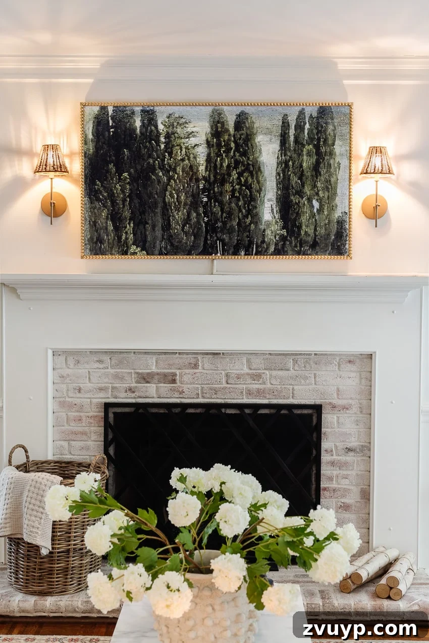 Give Your Samsung Frame TV a Bobbin Frame Makeover 2 DIY bobbin frame on a Samsung frame TV above a fireplace, flanked by rattan sconces, showcasing a blend of traditional and modern decor
