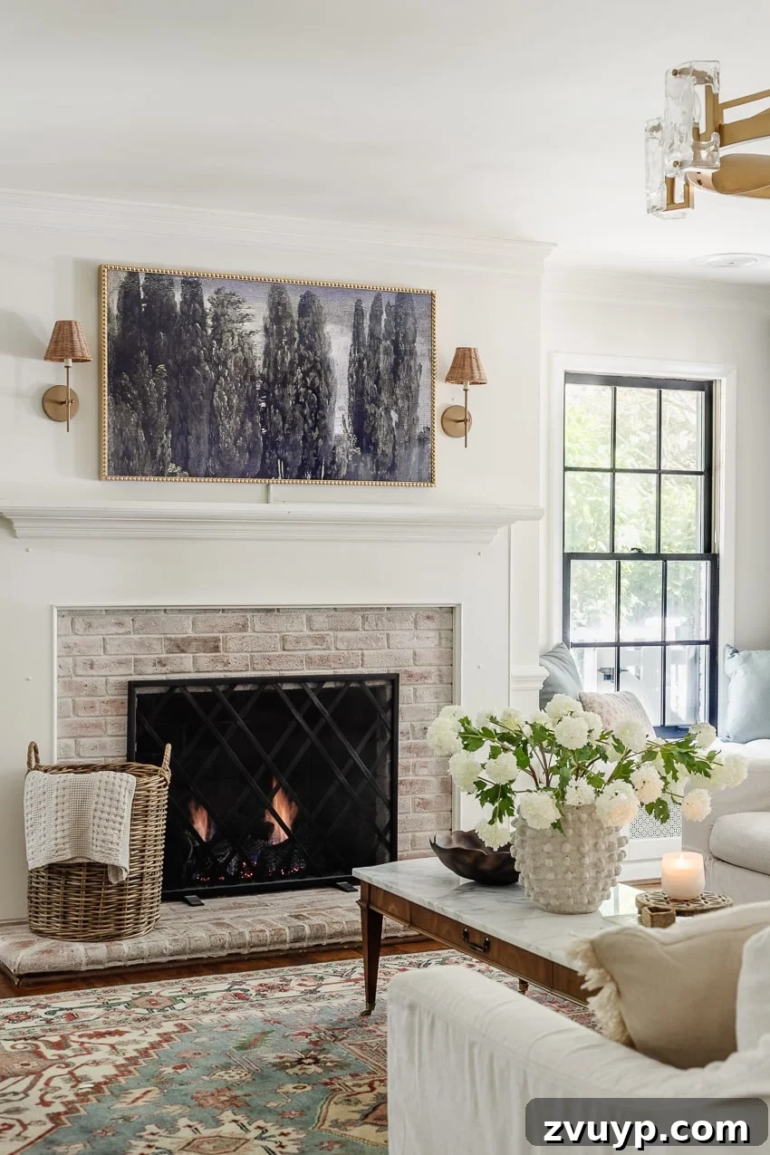 Give Your Samsung Frame TV a Bobbin Frame Makeover 9 DIY bobbin frame on a Samsung Frame TV mounted above a limewashed brick fireplace, adorned with elegant rattan sconces, creating a refined focal point in the living room