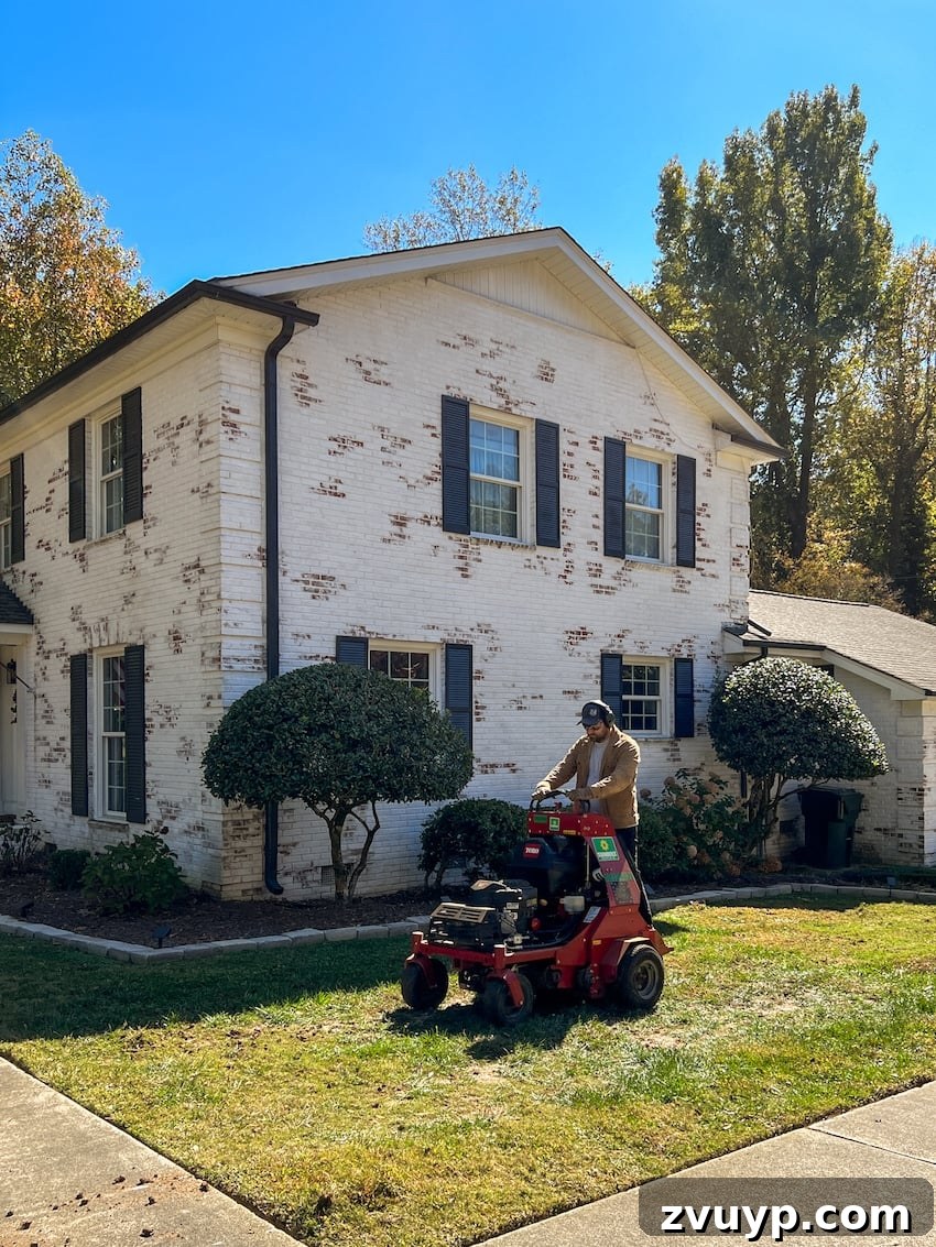 From Patchy to Pristine Our One-Year Front Yard Makeover 8 riding on an aerator on a lawn in the fall for planting grass seed