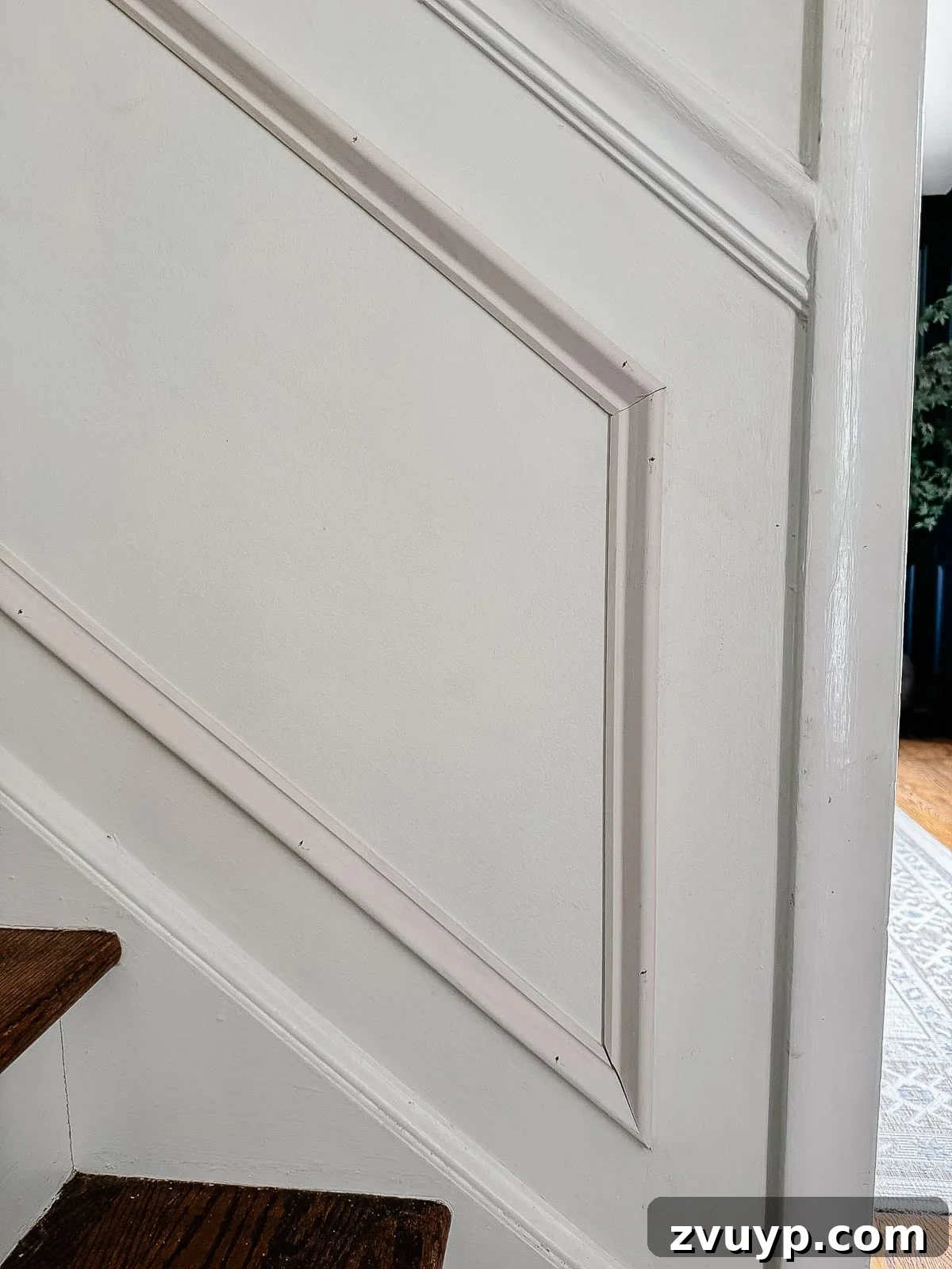 Transform Your Stairs: Effortless DIY Wainscoting Guide 12 Angled picture frame molding perfectly installed on stairs