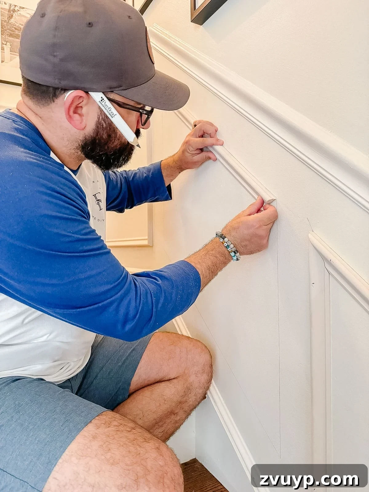 Transform Your Stairs: Effortless DIY Wainscoting Guide 13 Installing picture frame molding on stairs with a brad nailer