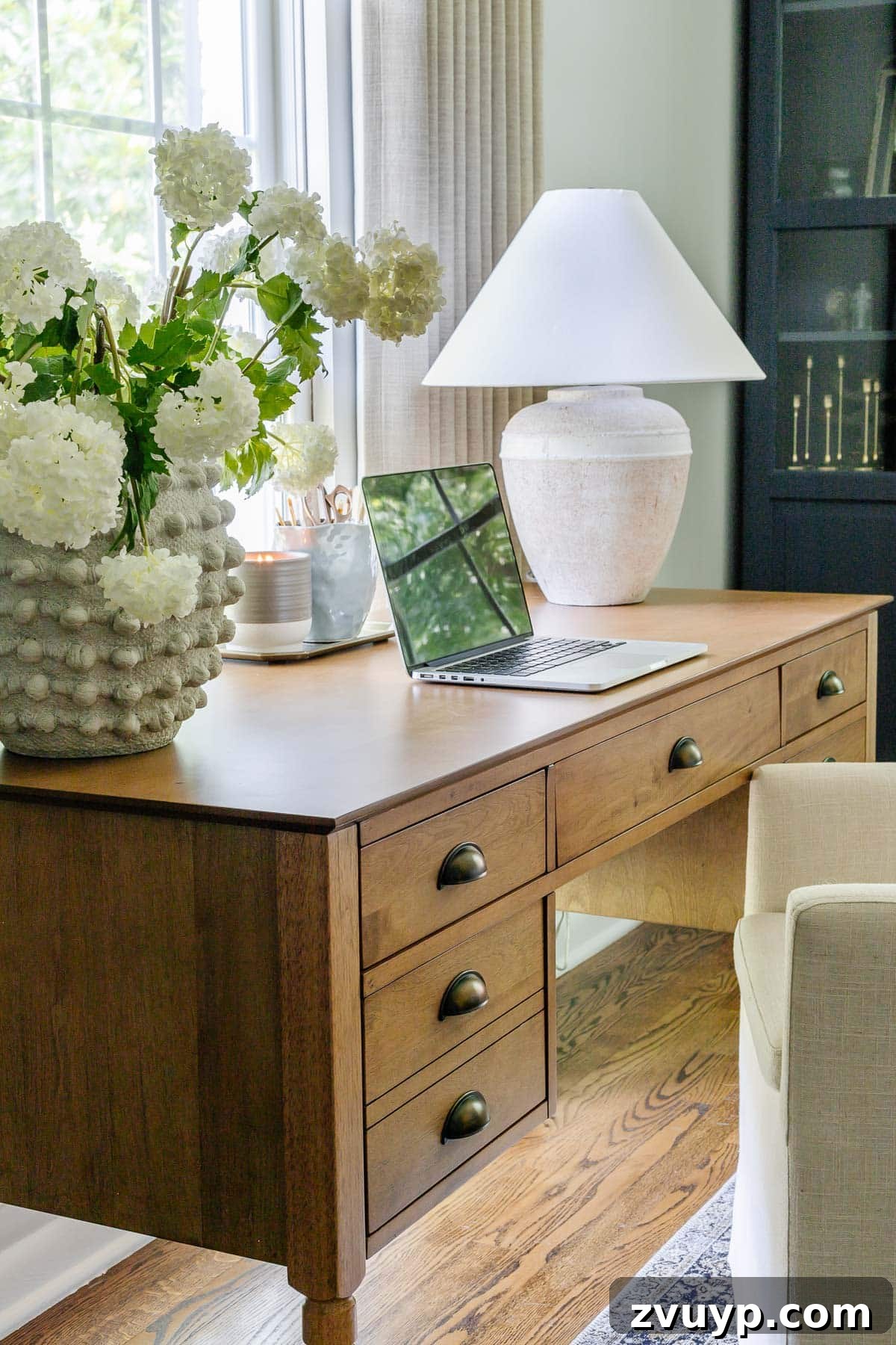 Power Up Your Productivity: Smart Home Office Layouts 7 A stylish vintage wood desk, perfectly positioned in a home office to enhance functionality and aesthetics.