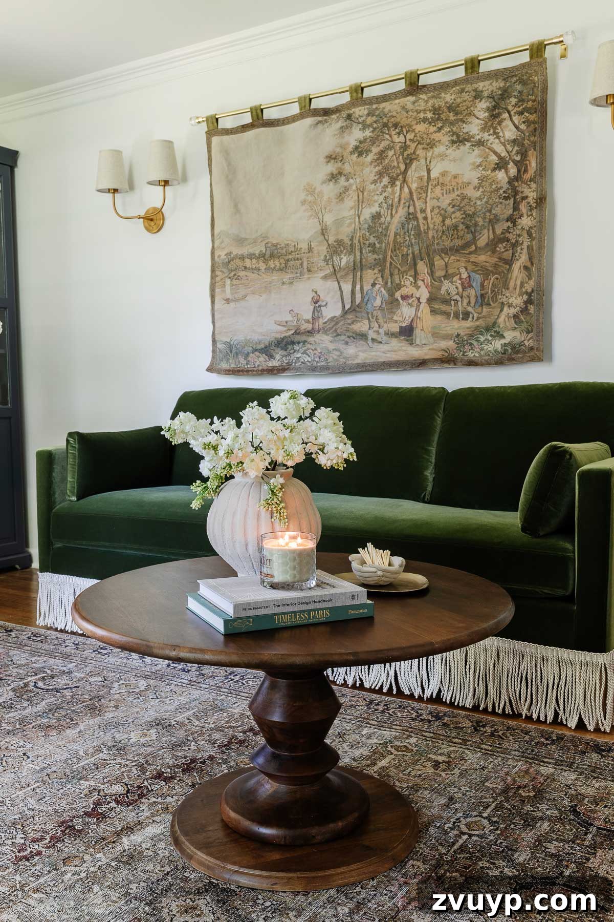 Instant Chic: DIY Fringe Trim for Your Seating 7 fringe trim added to a green velvet sofa with a styled coffee table and tapestry in a home office