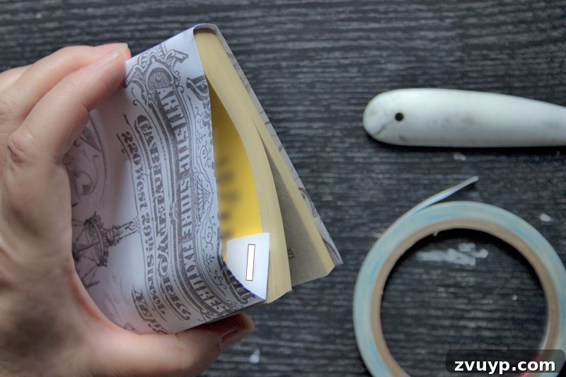 wrapping book - Applying ScorTape to secure the inner flap of the book cover